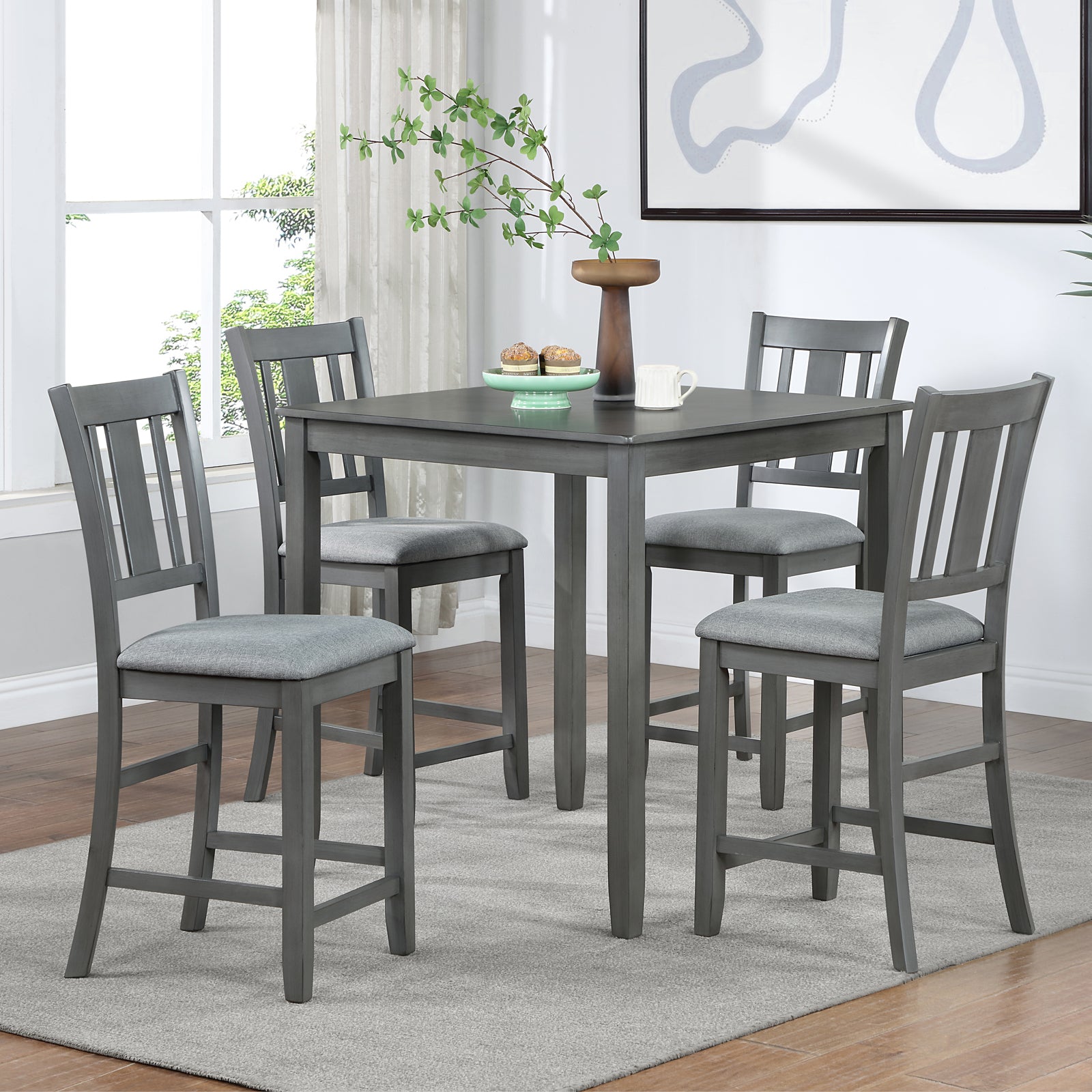 Gray wooden bar table with upholstered stools for dining room seating
