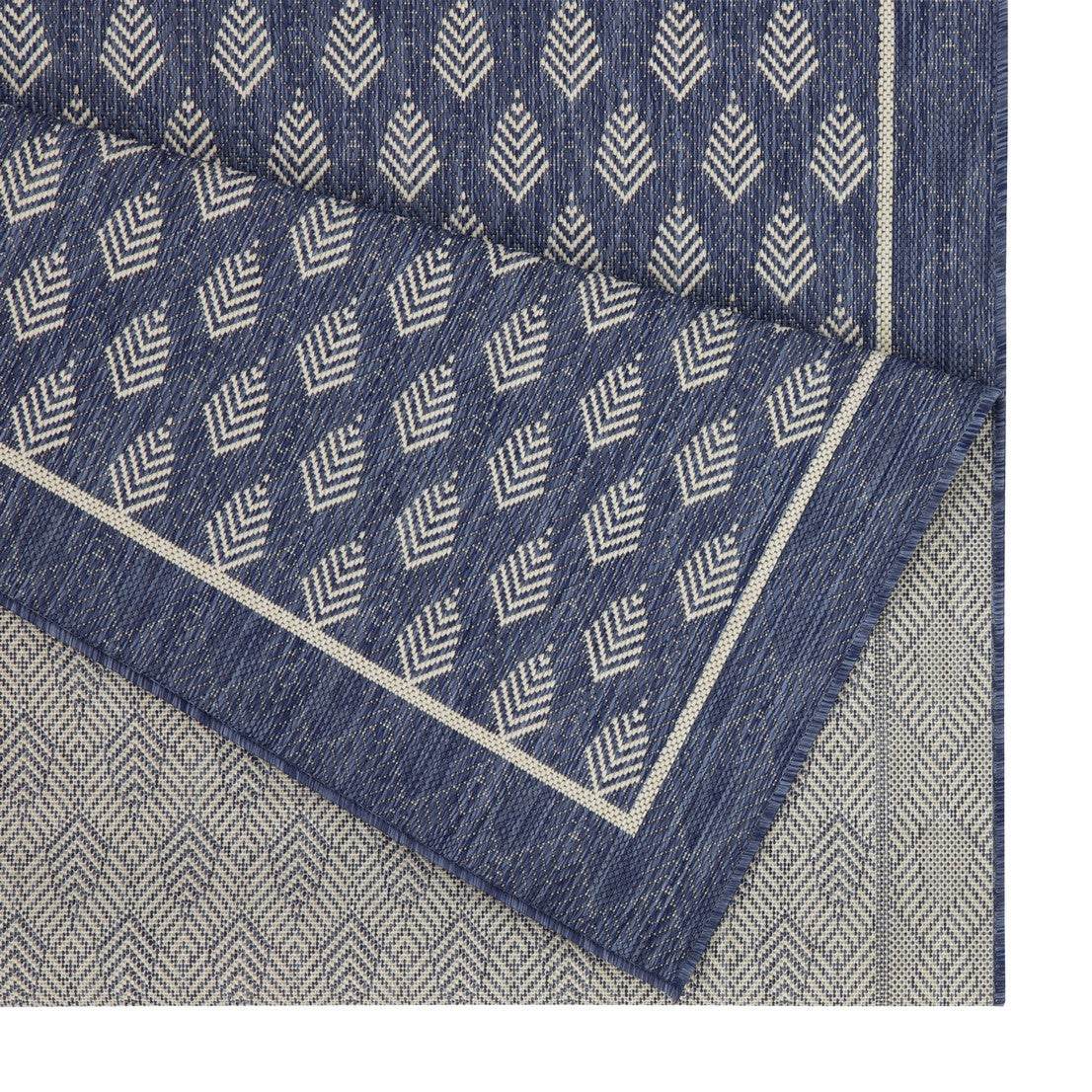 Navy blue outdoor rug with diamond pattern and cream border