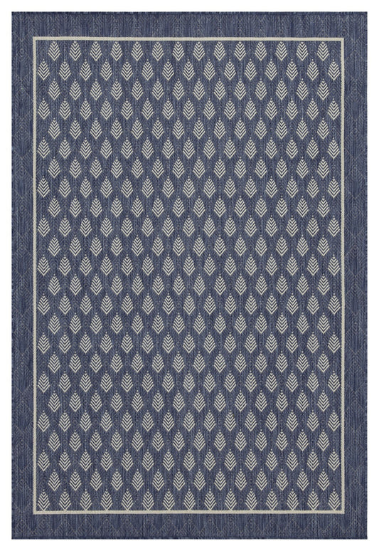 Navy blue outdoor rug with a repeating diamond leaf pattern and cream border