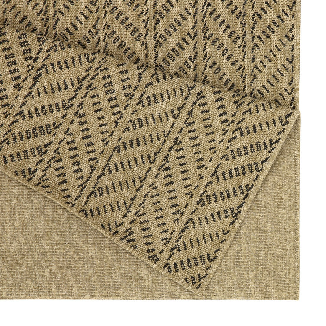 Closeup of a woven jute rug with a neutral beige base and a black geometric chevron pattern
