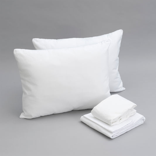 Two fluffy white pillows and a stack of crisp white pillowcases on a grey background
