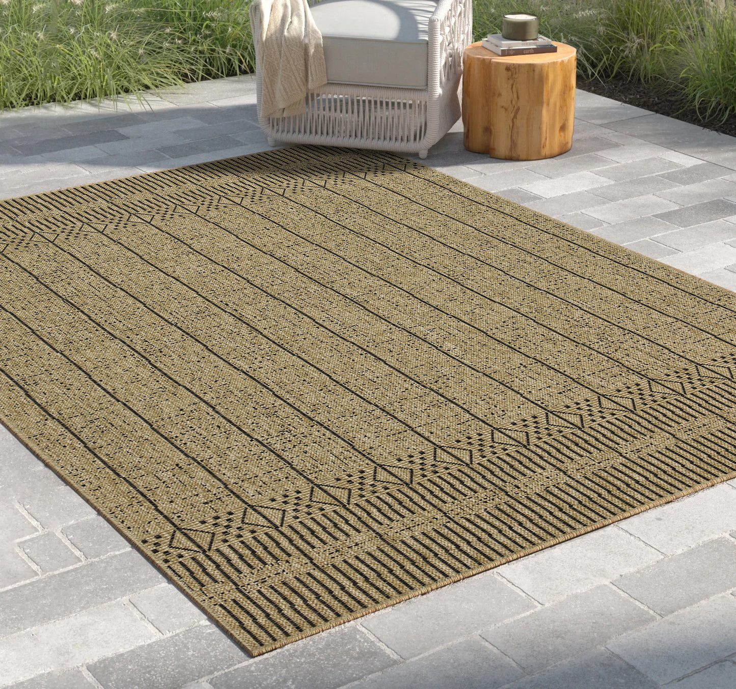 Textured tan and black striped outdoor rug with geometric border pattern