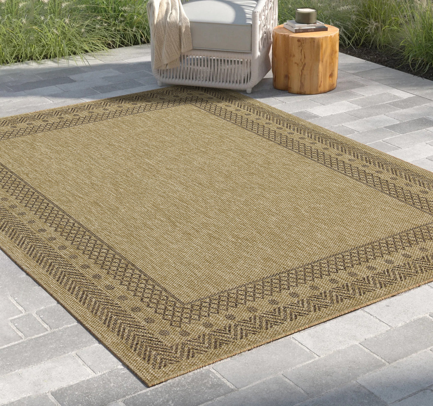 Flat weave outdoor rug in tan with a geometric brown border perfect for patios