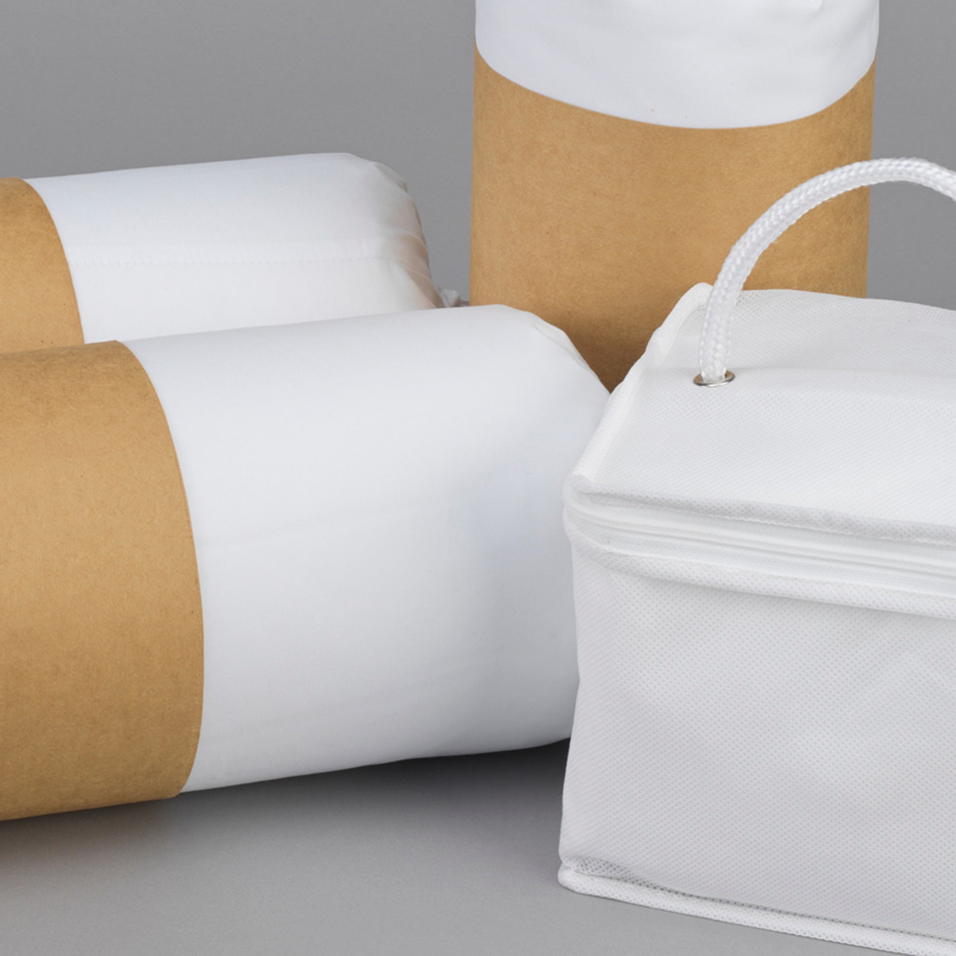 Rolled white pillow with brown kraft paper packaging ideal for shipping delicate bedding