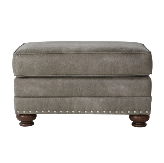 Grey faux leather ottoman with silver nailhead trim and wooden legs