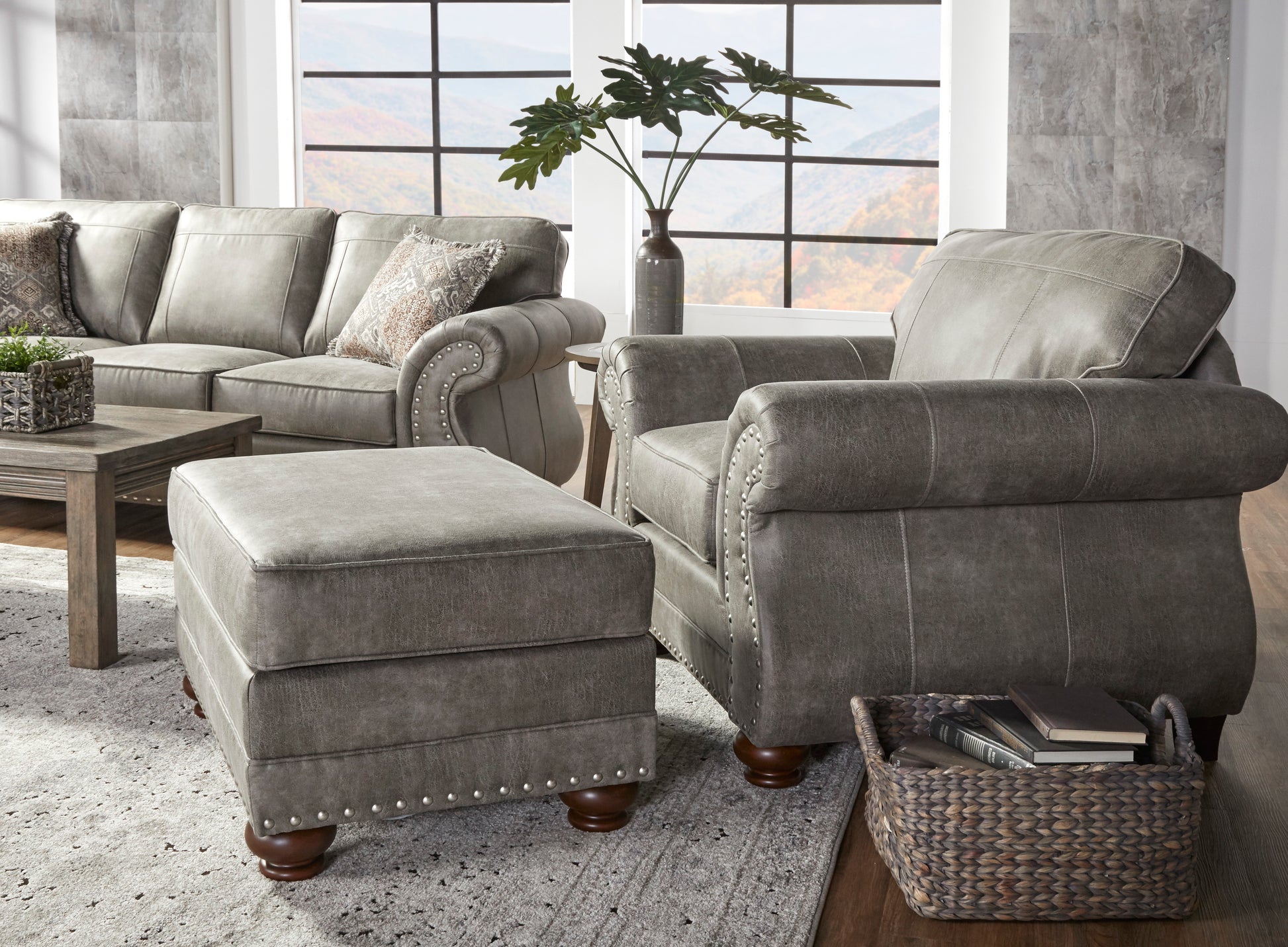 Gray leather armchair with studded details and plush cushioning