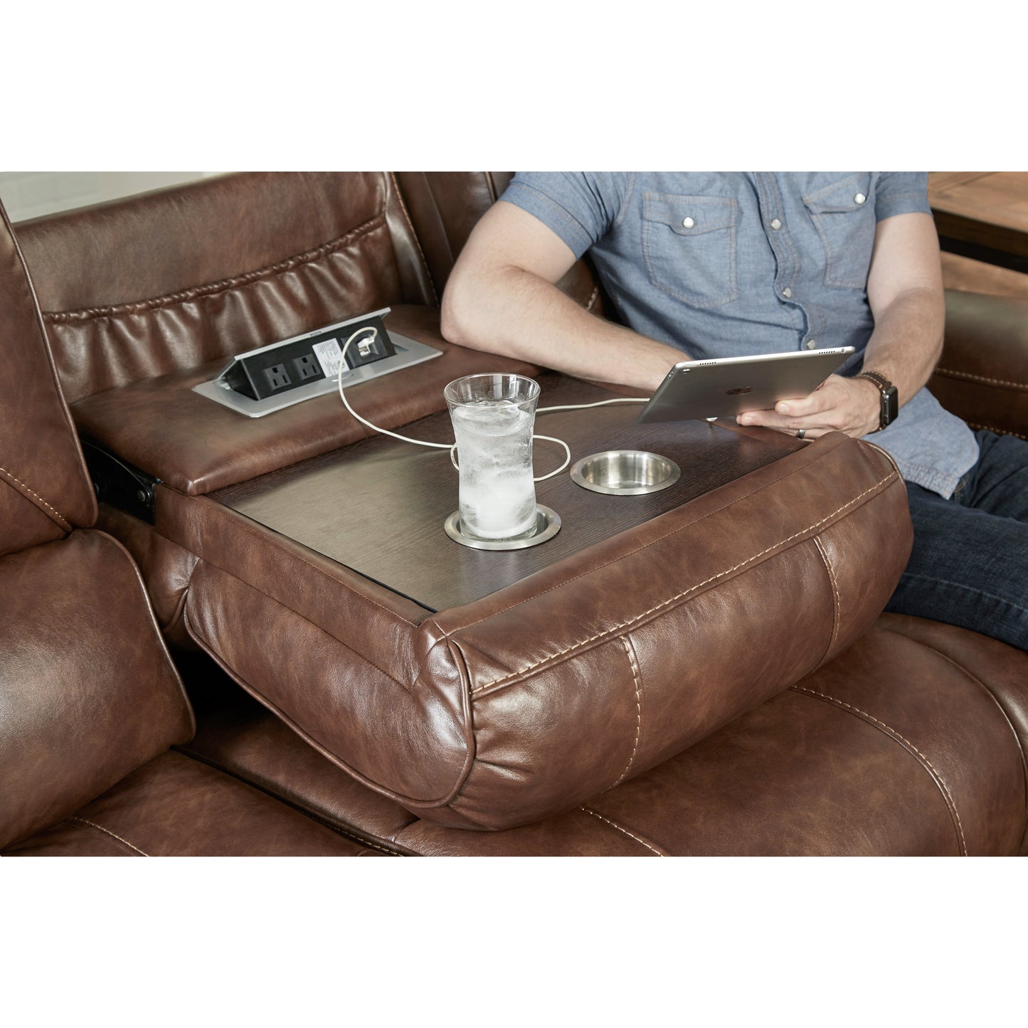 Brown leather reclining sofa with builtin power hub and cup holder