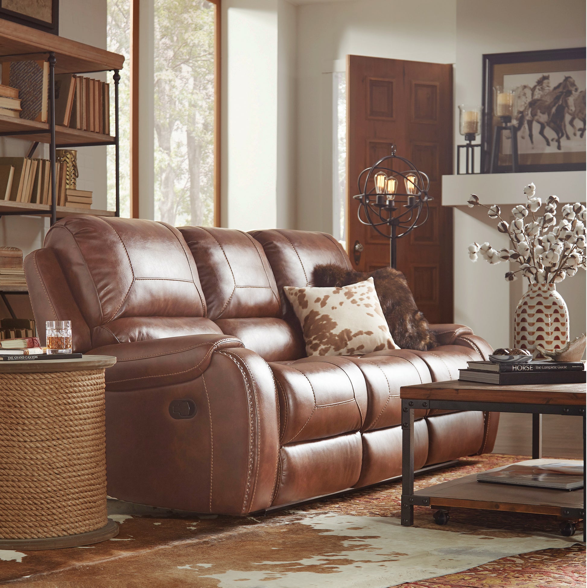 Brown leather reclining sofa with detailed stitching ideal for a rustic living room setup
