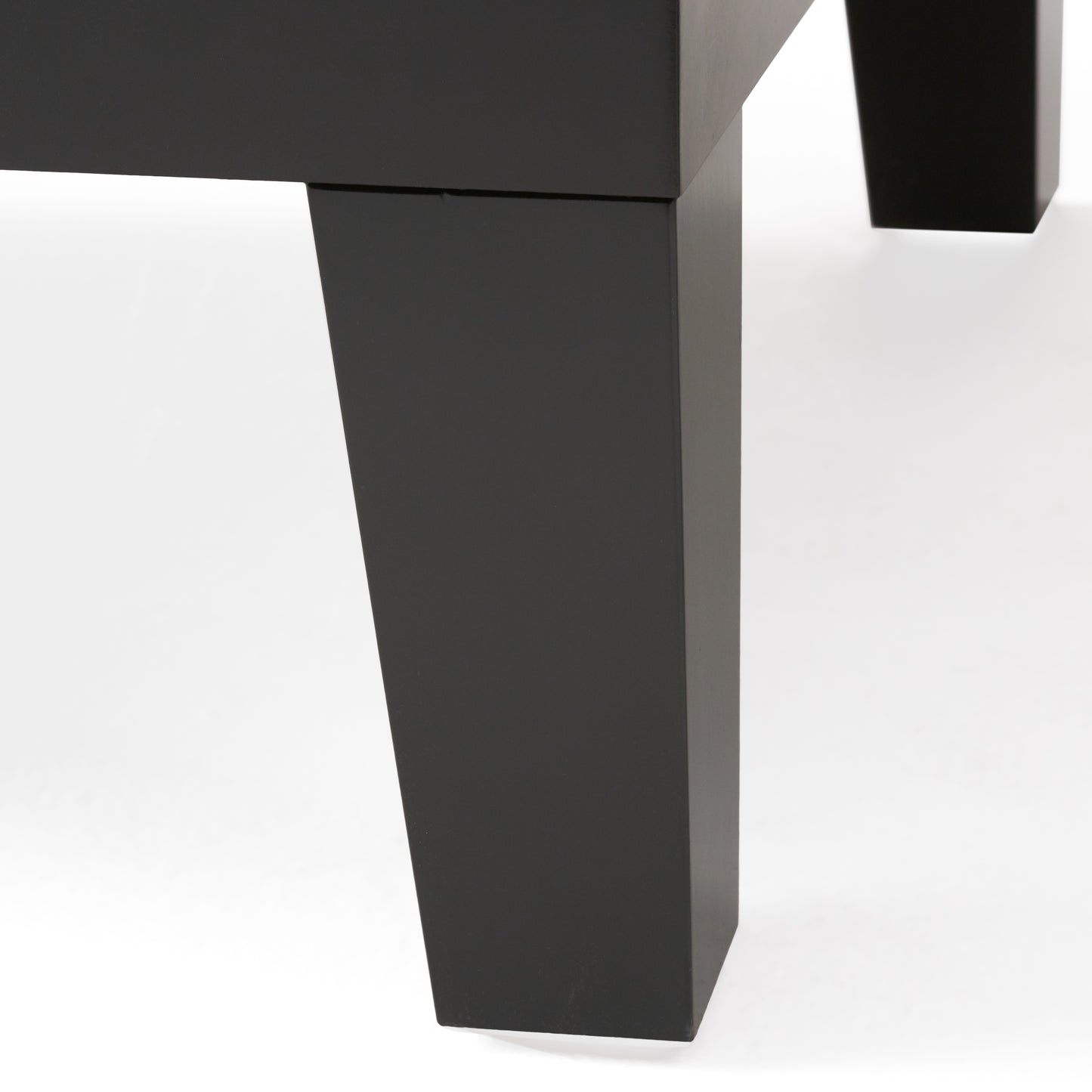Closeup of a modern black metal table leg showcasing its sleek geometric design