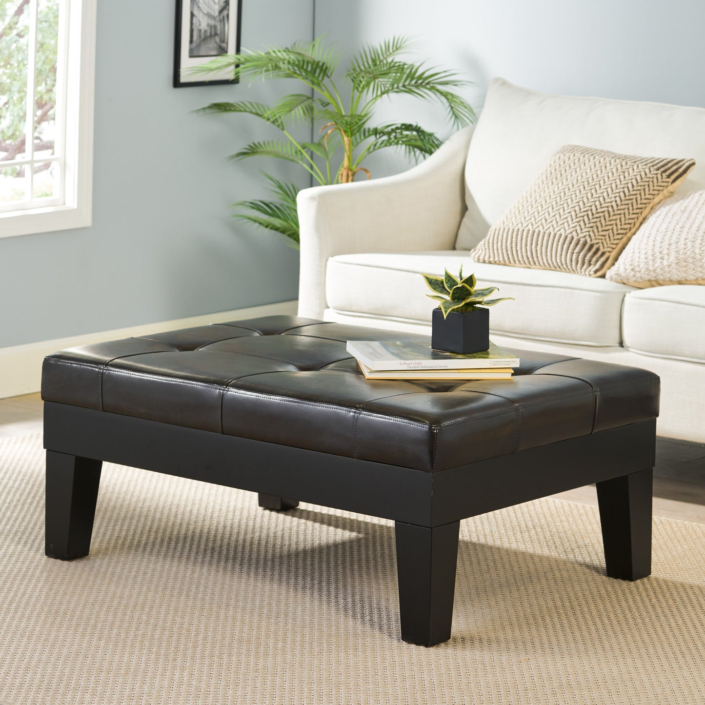 Tufted dark brown faux leather storage ottoman with clean lines and wooden legs perfect for living rooms