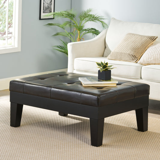 Tufted dark brown faux leather storage ottoman with clean lines and wooden legs perfect for living rooms