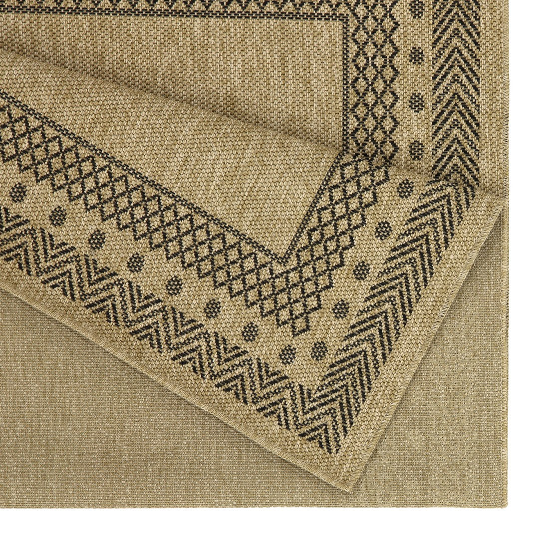 Tan textured rug with black geometric border pattern and folded corner