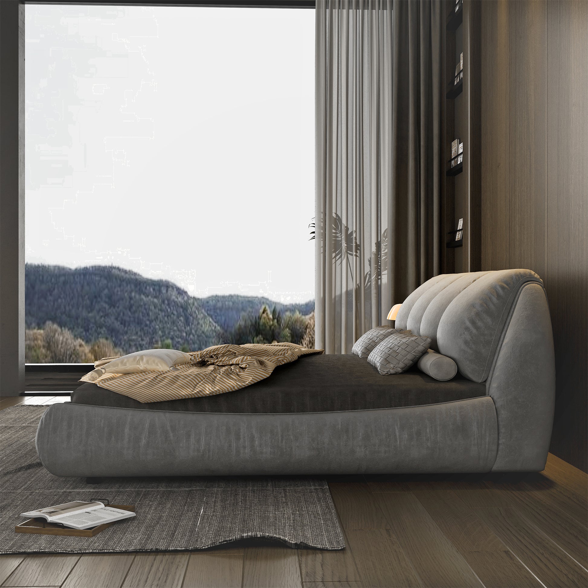Grey upholstered bed with plush headboard and striped throw blanket