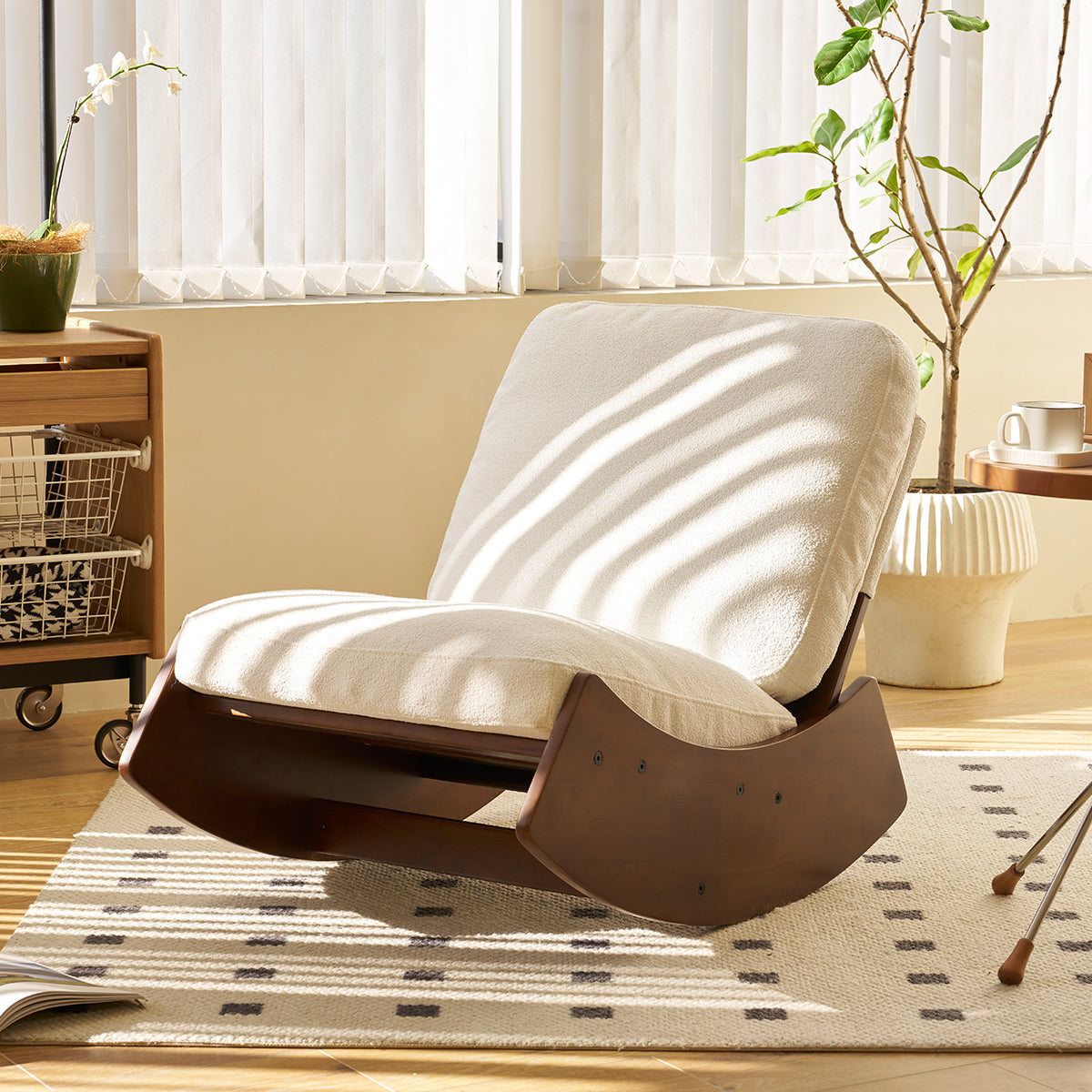 Plush cream fabric rocking chair with dark wood curved base perfect for nurseries