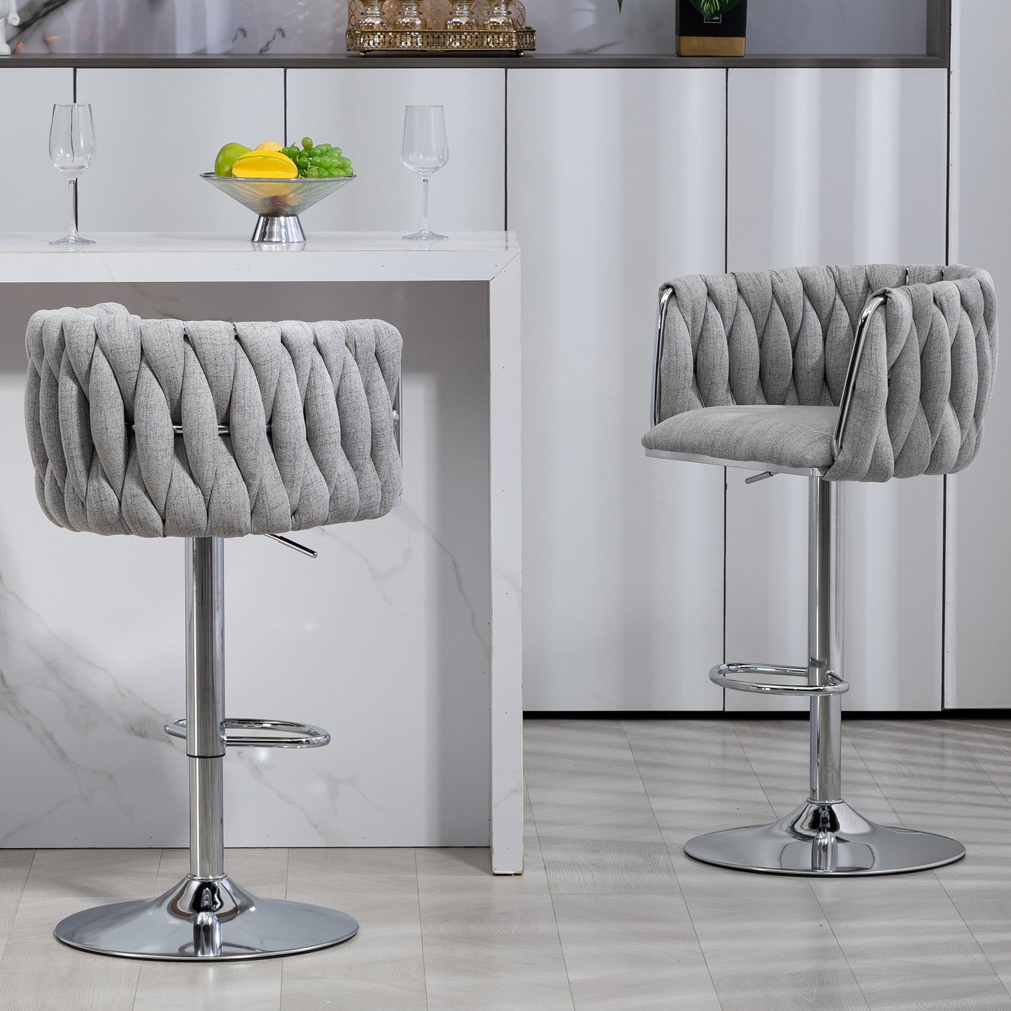 Gray upholstered bar stool with braided detail and chrome base