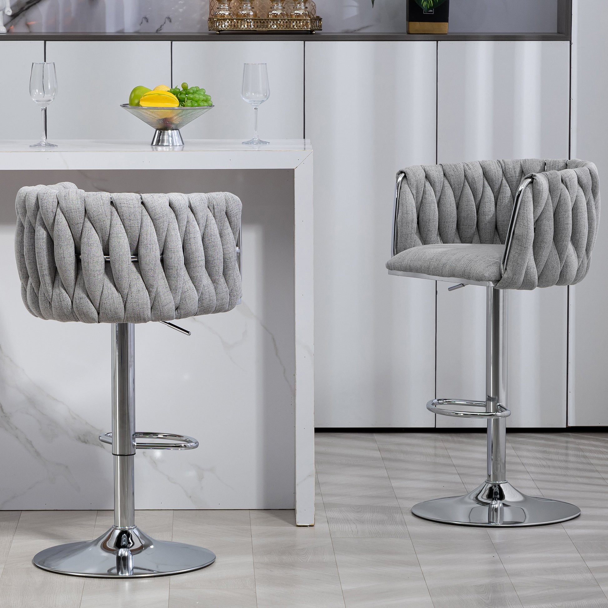 Gray upholstered bar stool with braided detail and chrome base