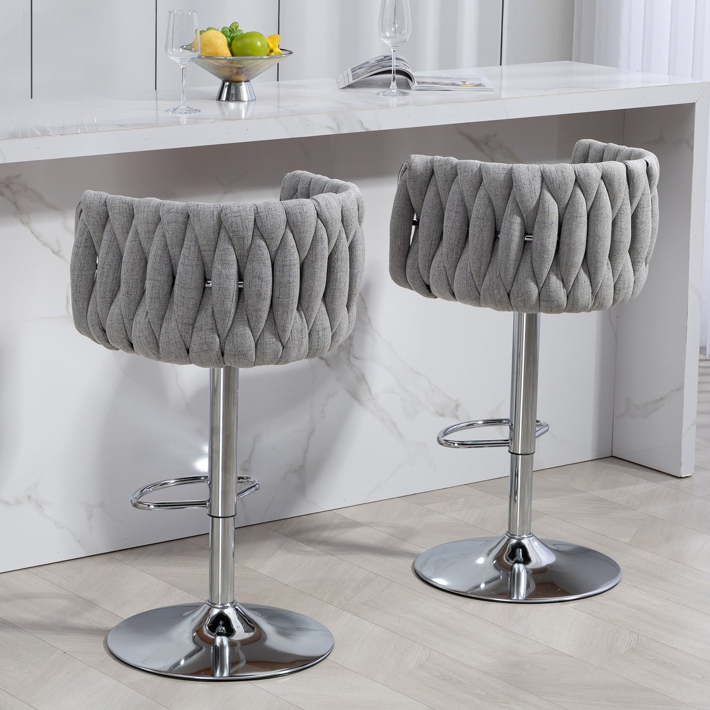Gray upholstered bar stool with braided detailing and chrome base for modern kitchen island