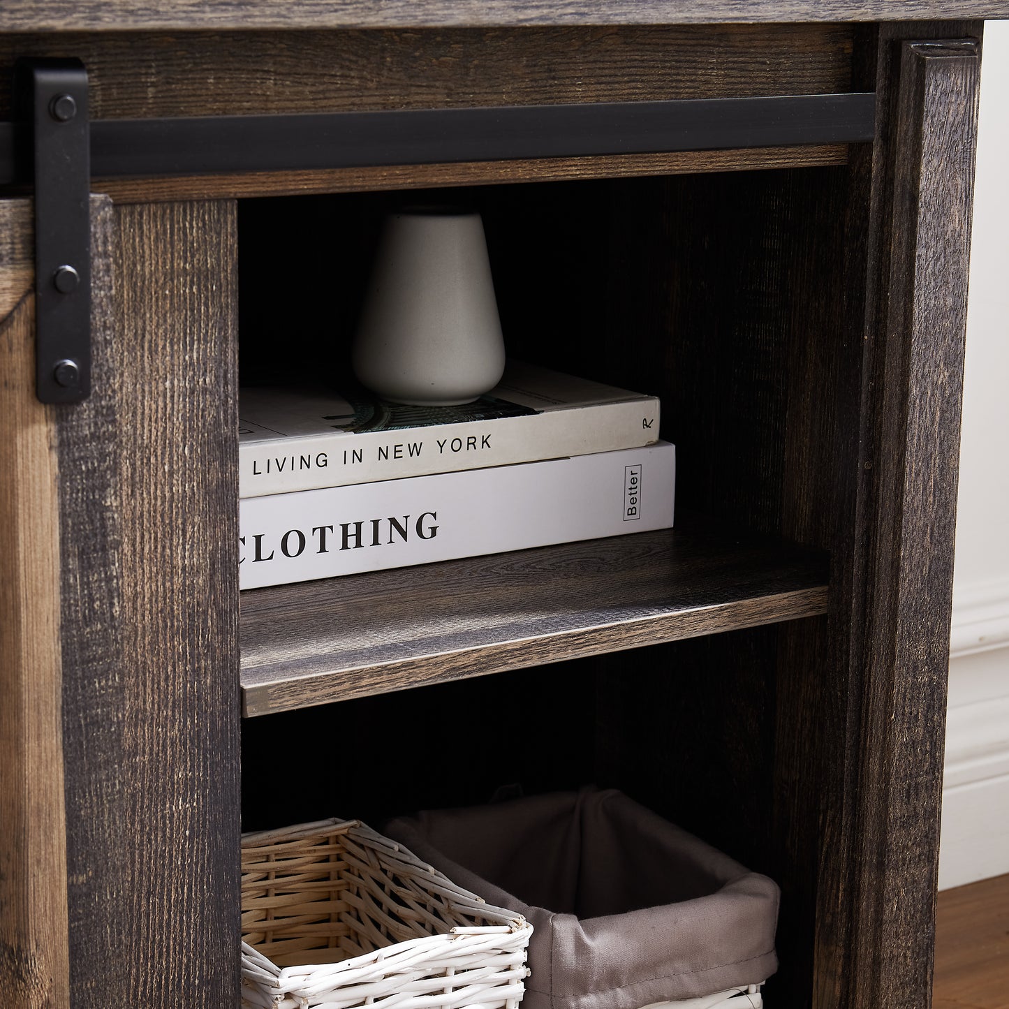 Rustic barn door TV stand with dark wood finish and black hardware