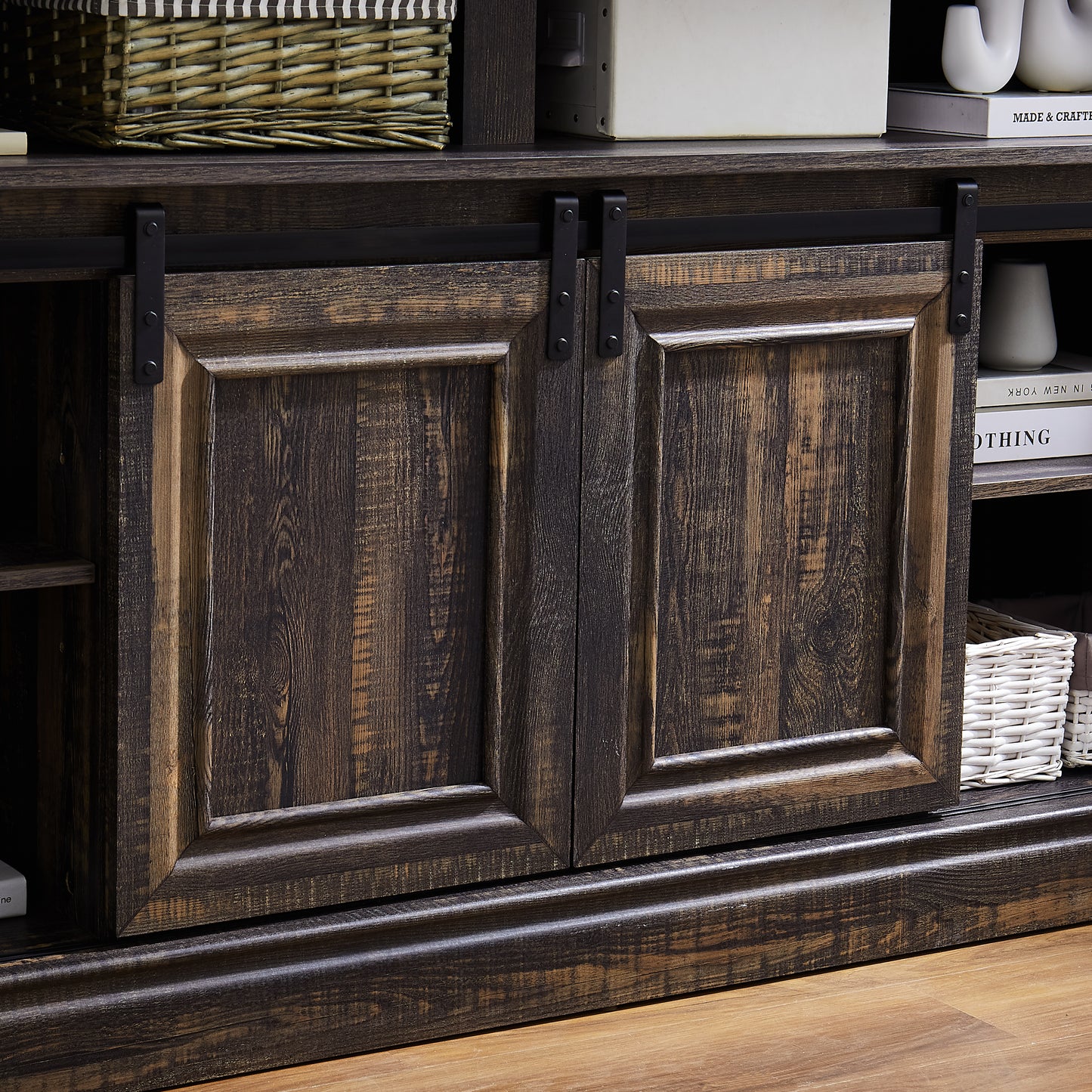 Dark wood media console with sliding barn doors and black hardware