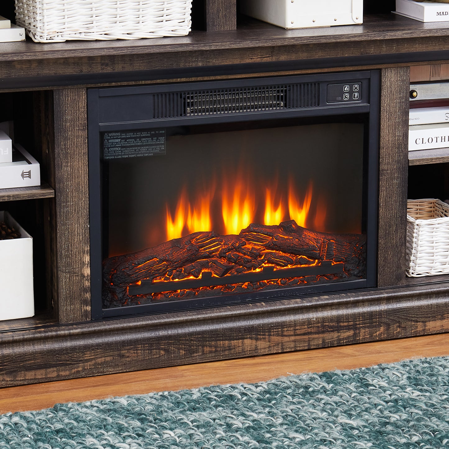 Realistic electric fireplace logs glowing with orange flames part of a rustic entertainment center