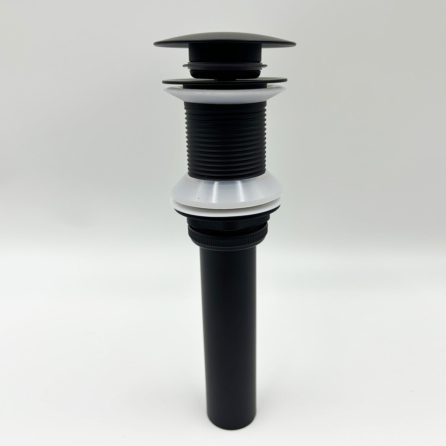 Black popup drain assembly with ribbed plastic body and white gasket seals