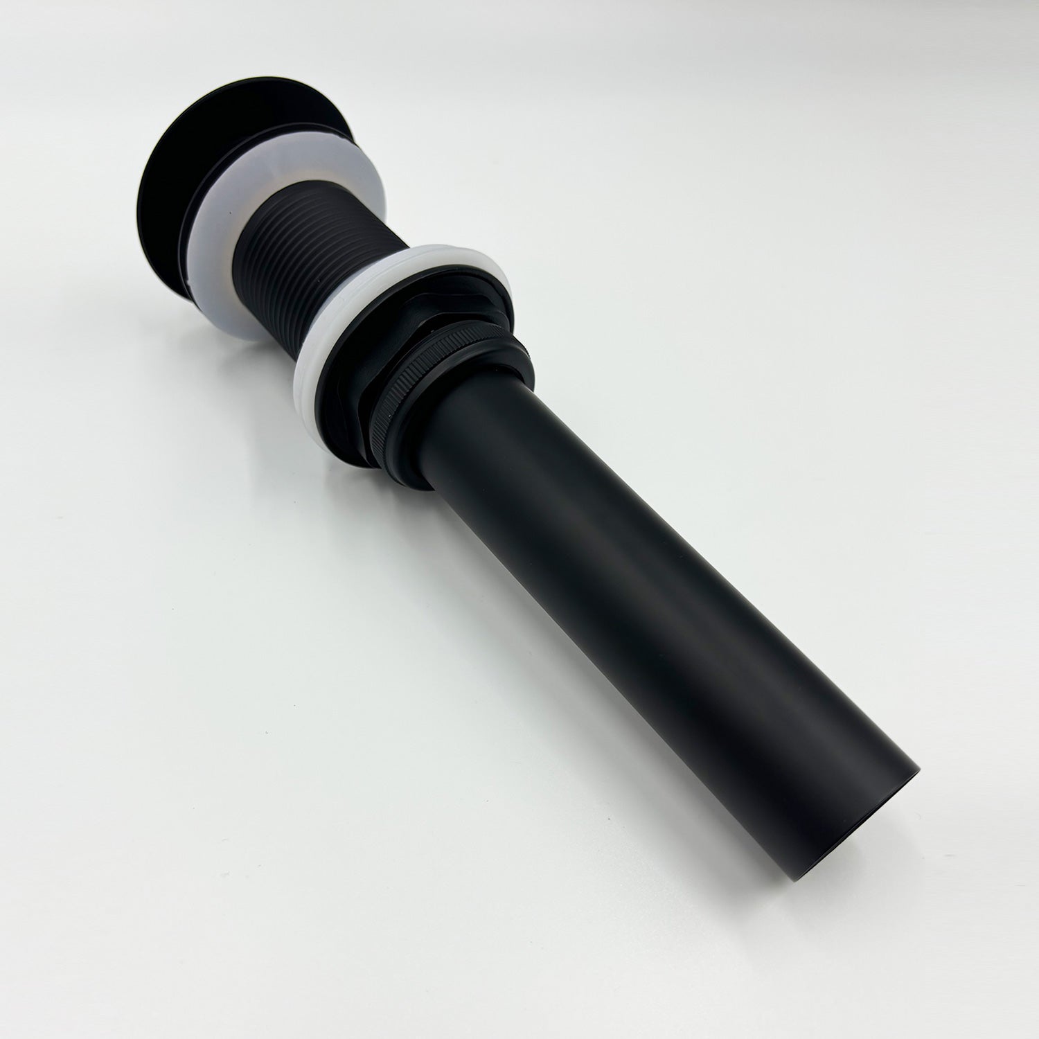 Matte black sink drain with white gaskets and ribbed body for bathroom vanities