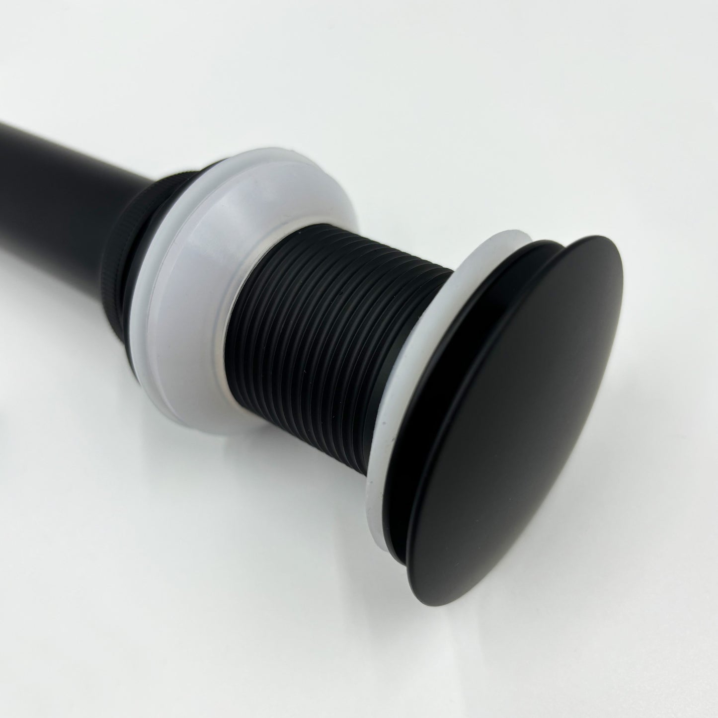 Matte black popup drain assembly with rubber seals for bathroom sinks