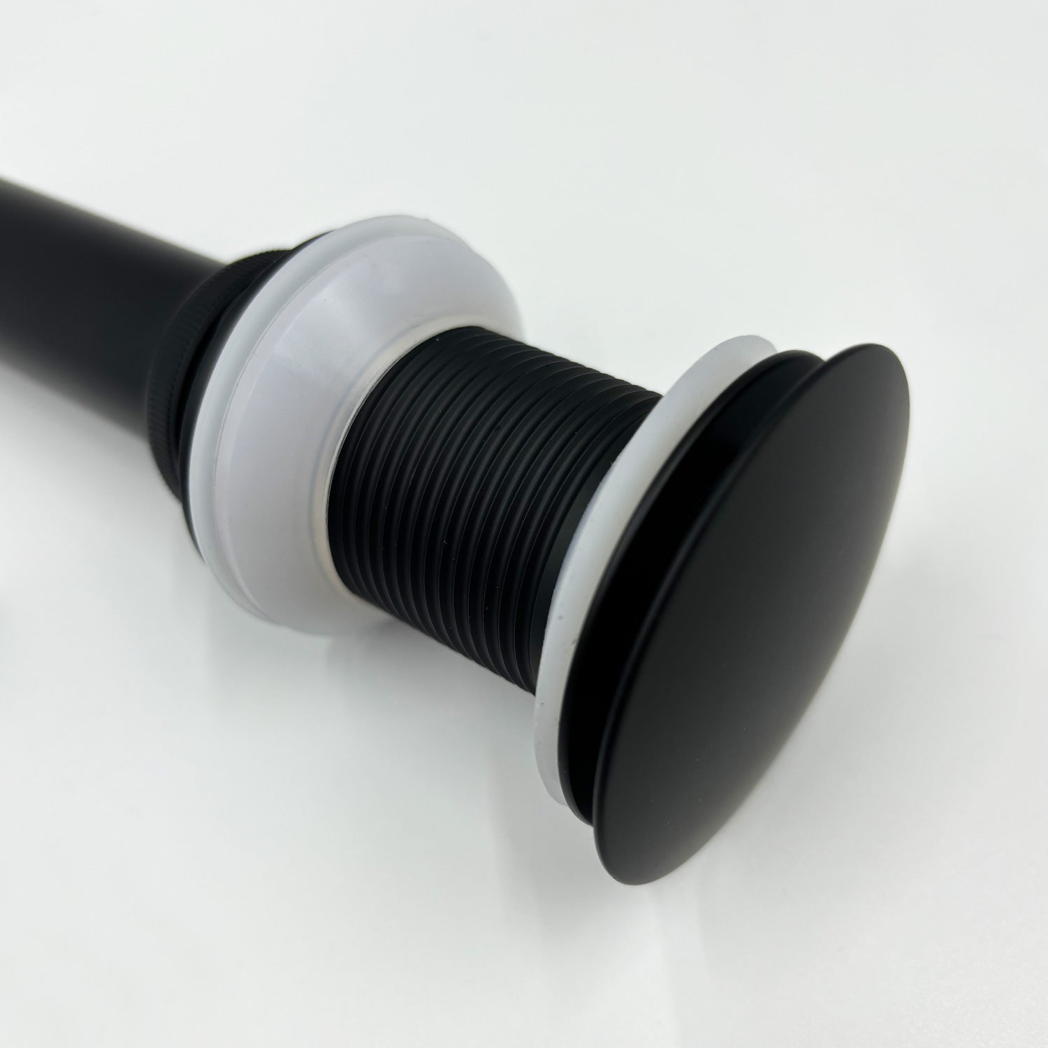 Matte black popup drain assembly with rubber seals for bathroom sinks