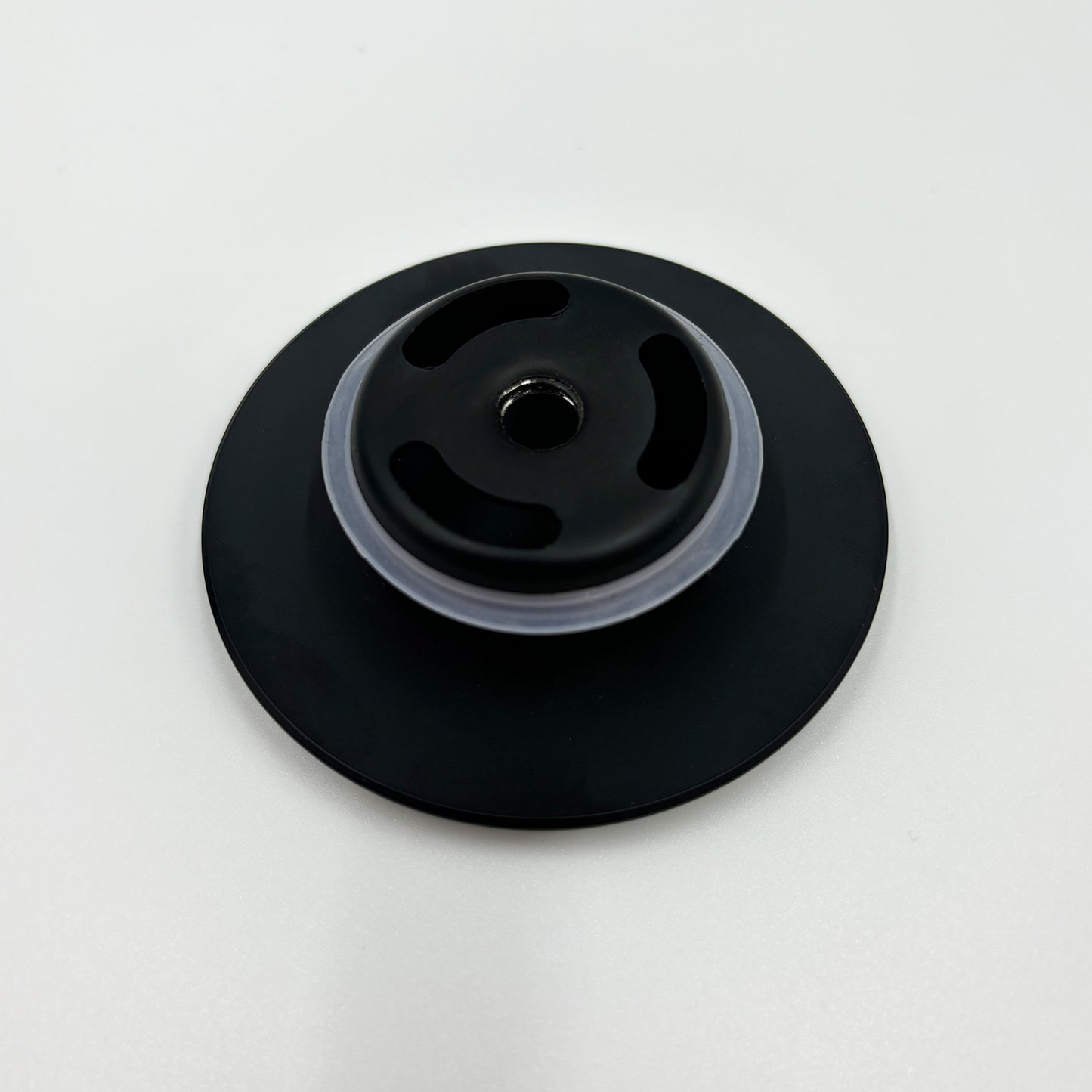 Black drain cover with textured vents and silicone seal