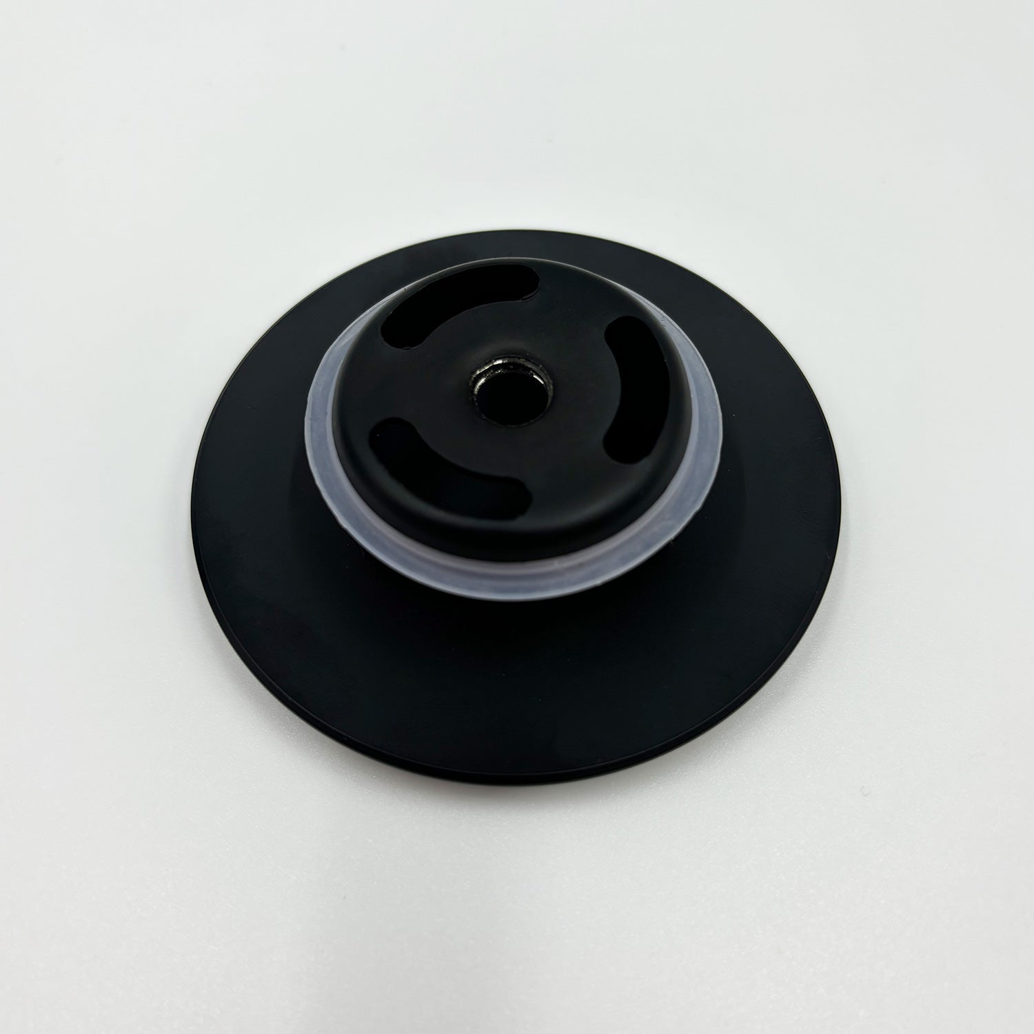 Black drain cover with textured vents and silicone seal