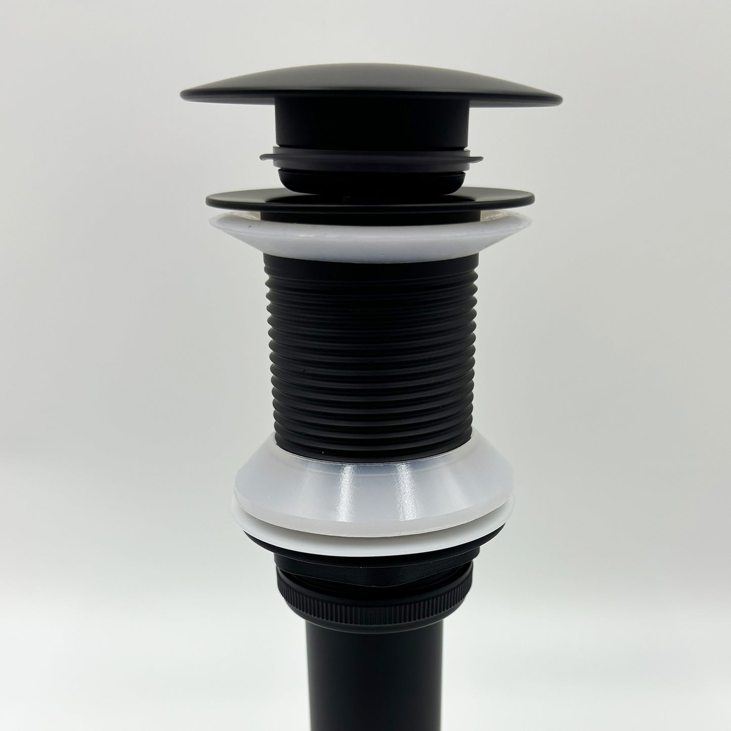 Black popup drain assembly with threaded pipe and plastic gaskets