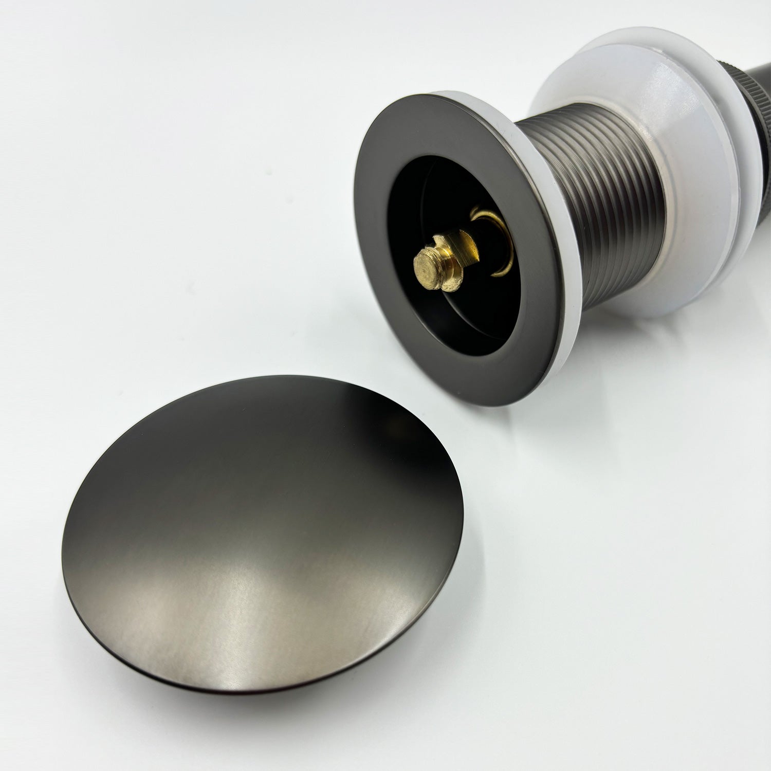 Matte black bathroom sink drain assembly with popup stopper