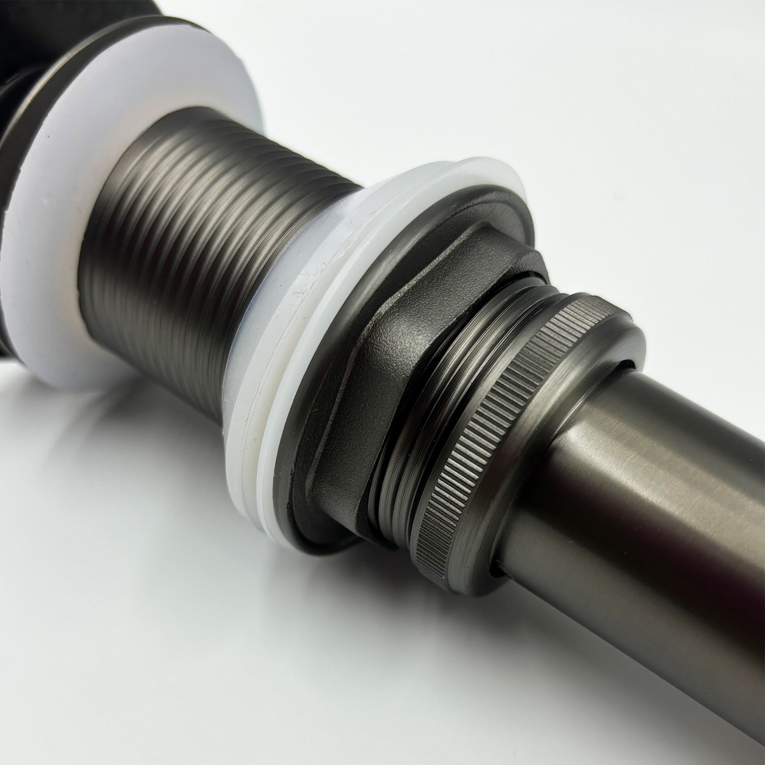 Gunmetal grey sink drain assembly with white rubber gaskets threaded metal pipe