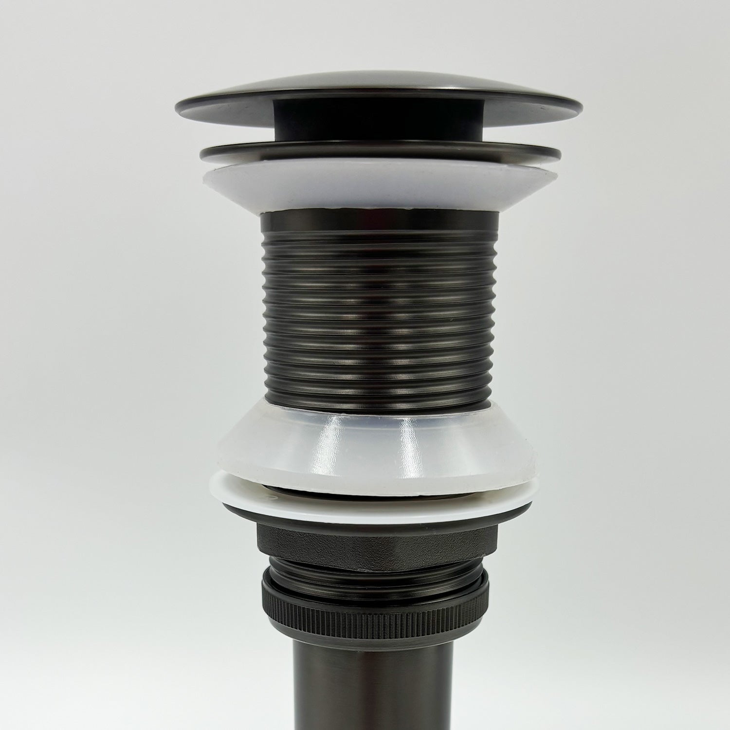 Oil rubbed bronze popup drain assembly with white gaskets for sink installation