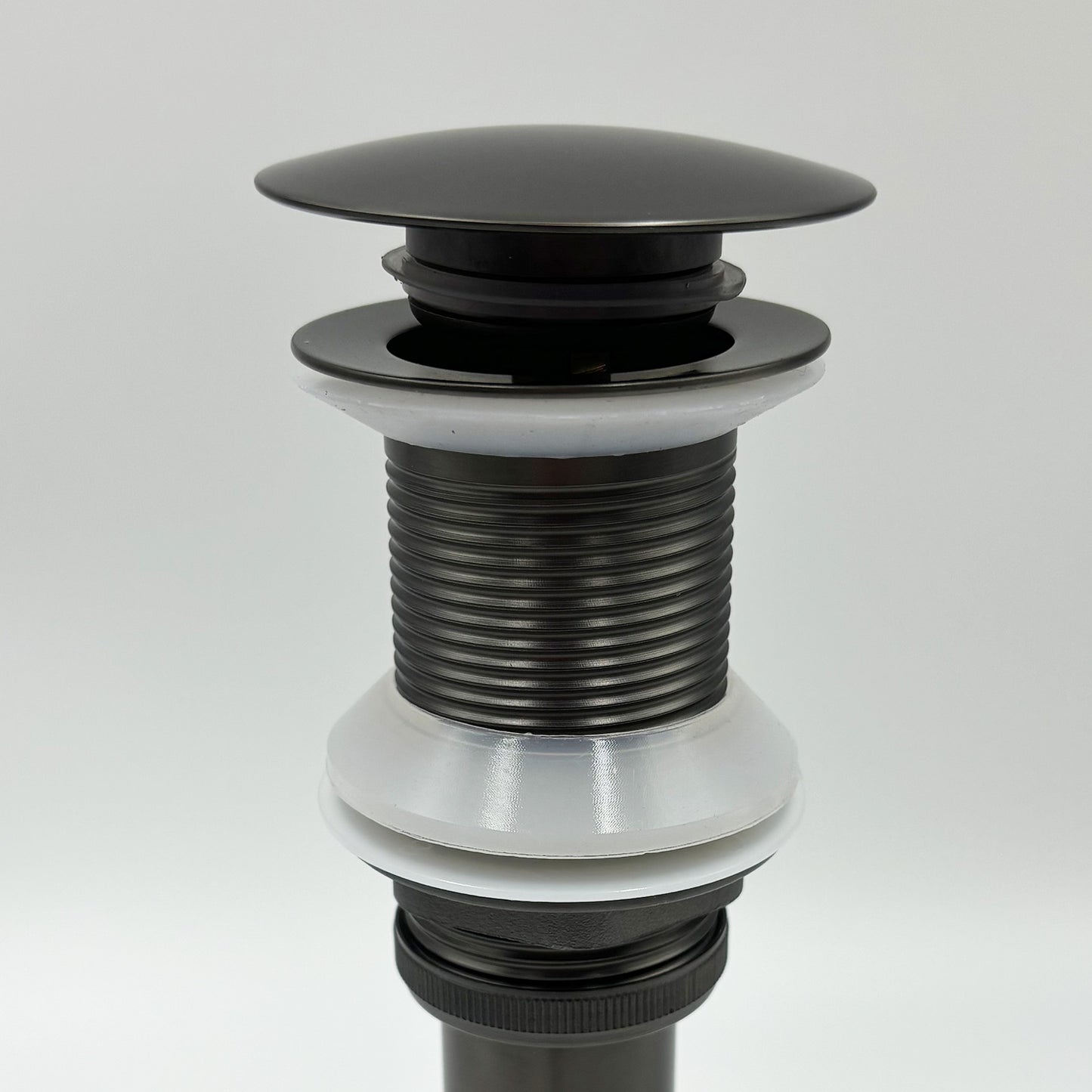 Black metal popup drain assembly with ribbed neck and white rubber seal