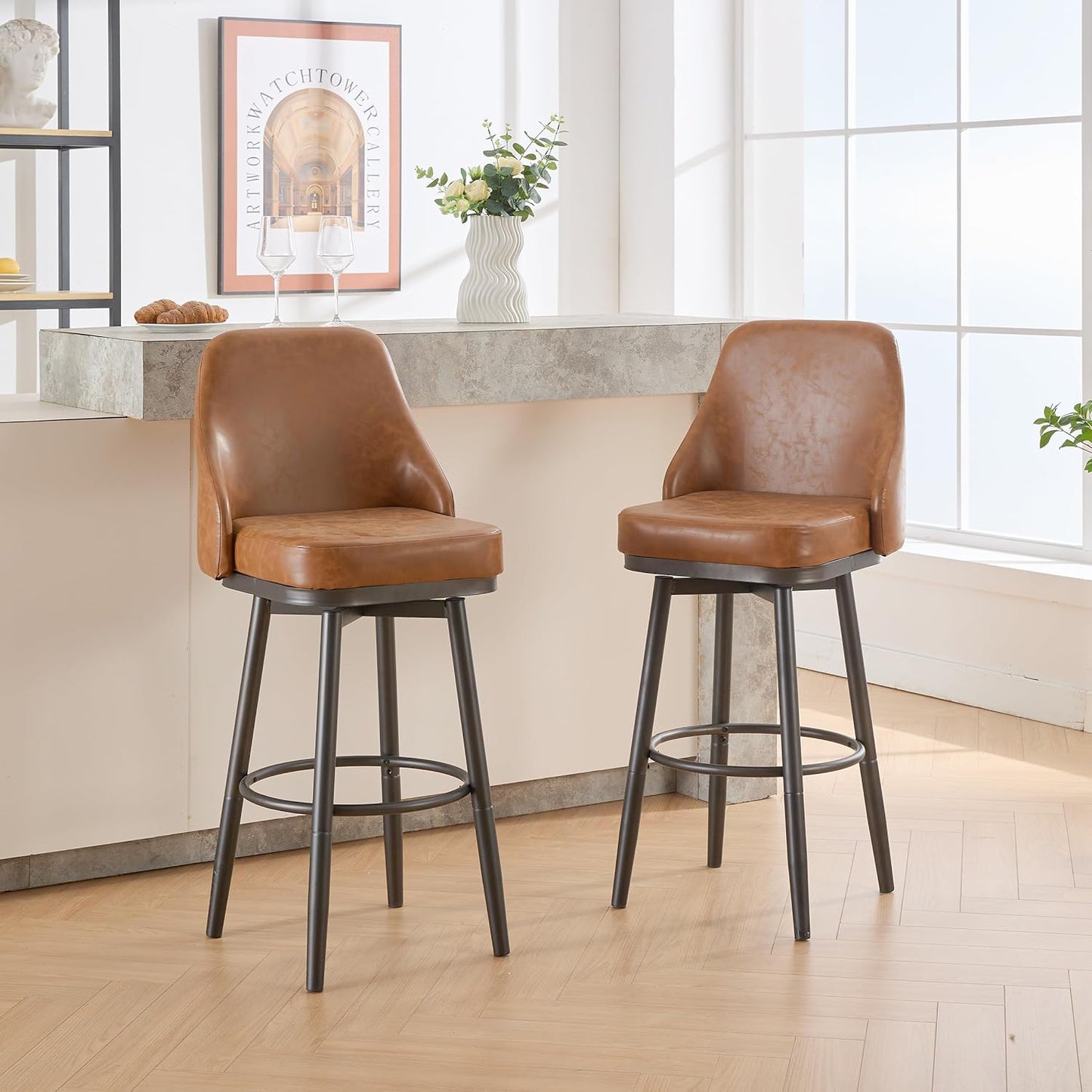 Two brown faux leather bar stools with black metal legs and footrests
