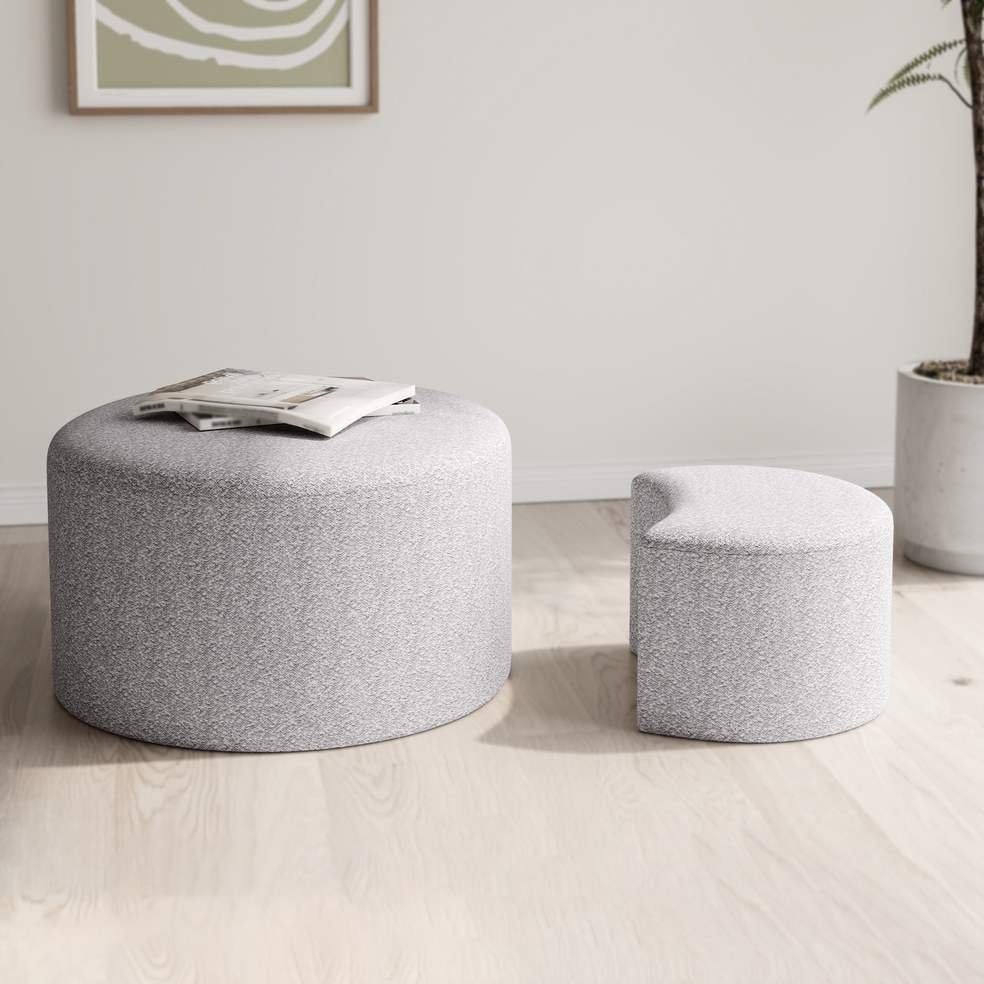 Round grey fabric ottoman with books on top for living room seating