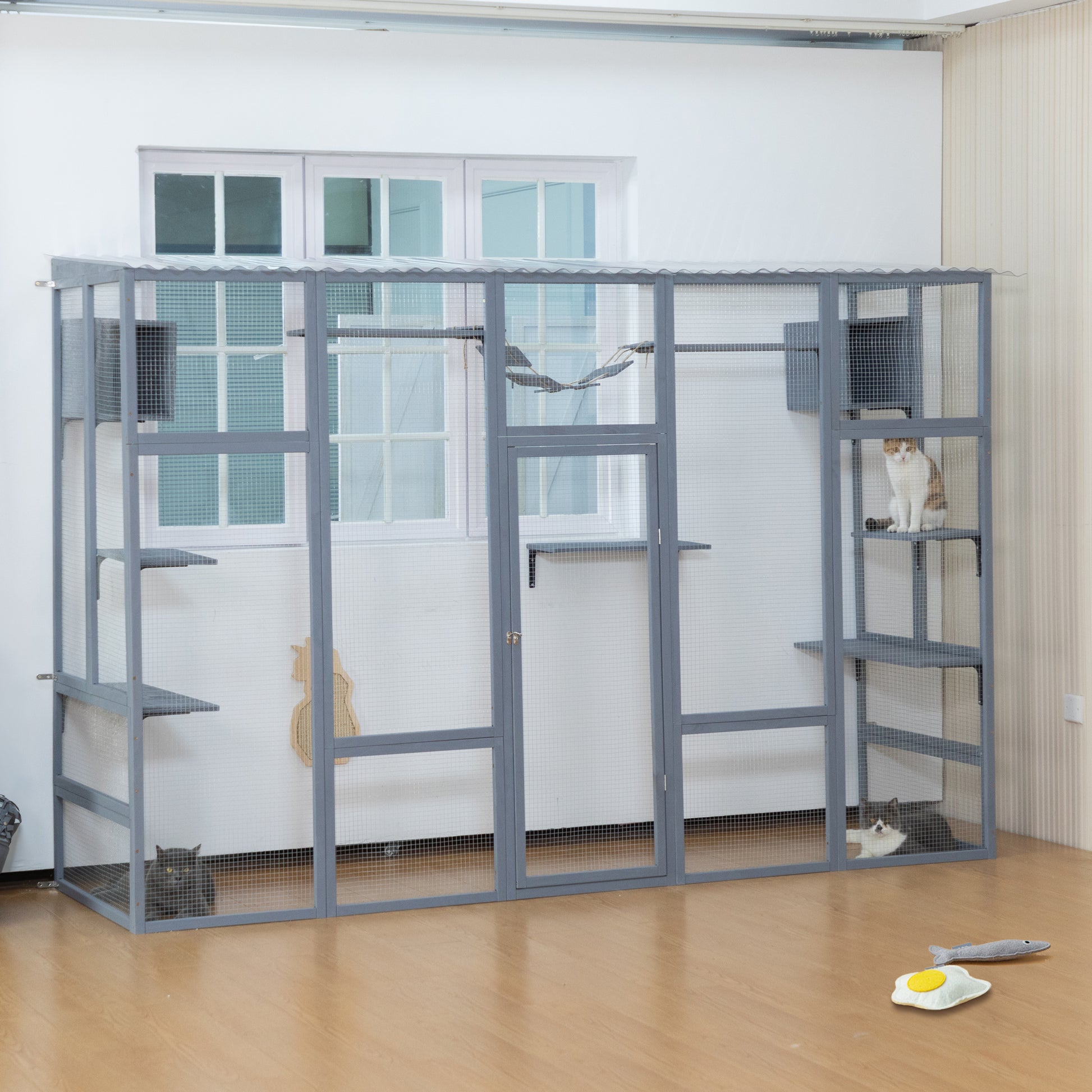 Spacious gray outdoor catio with multiple levels perches and two cats enjoying playtime