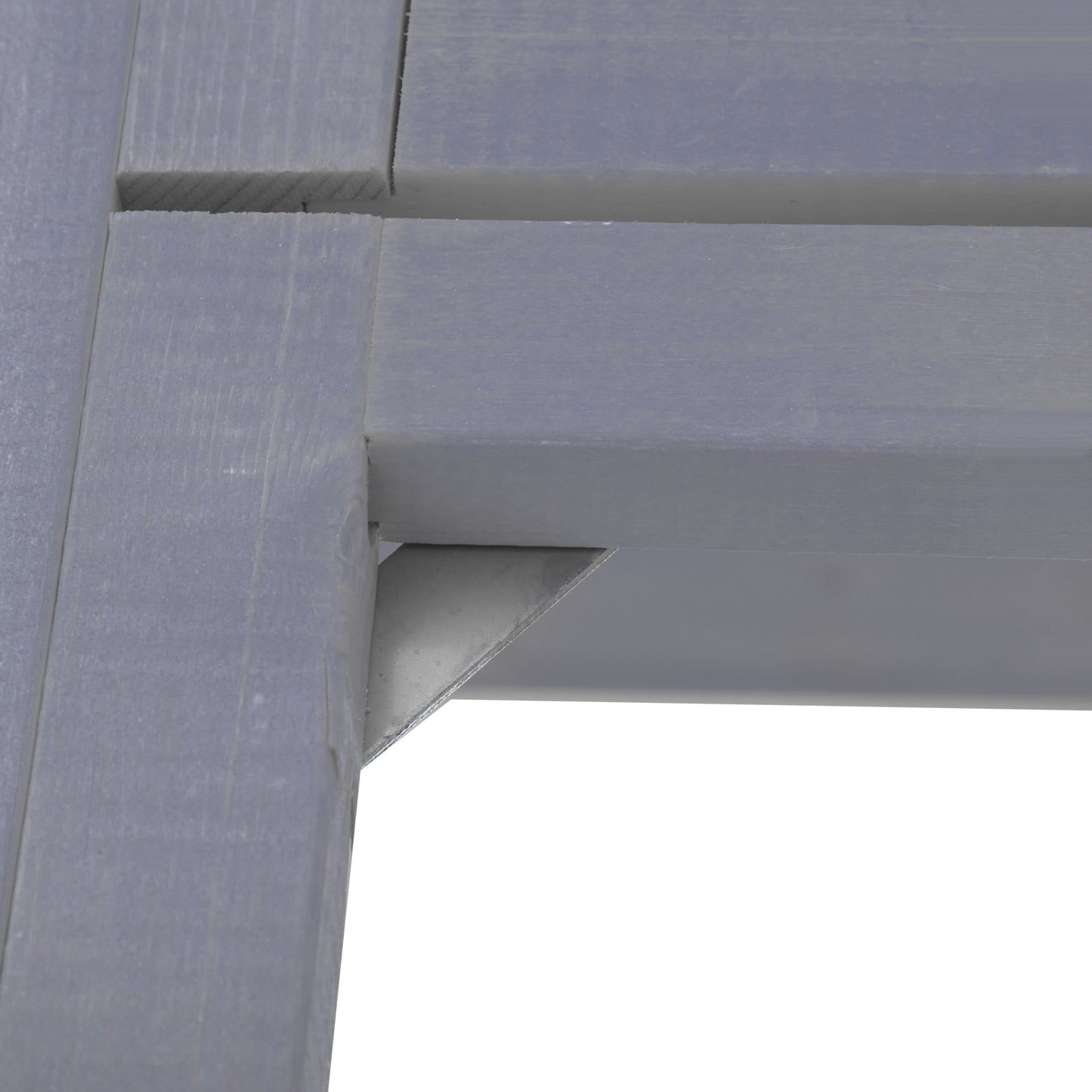 Closeup of grey wooden slats with a metal bracket showing construction detail of outdoor furniture