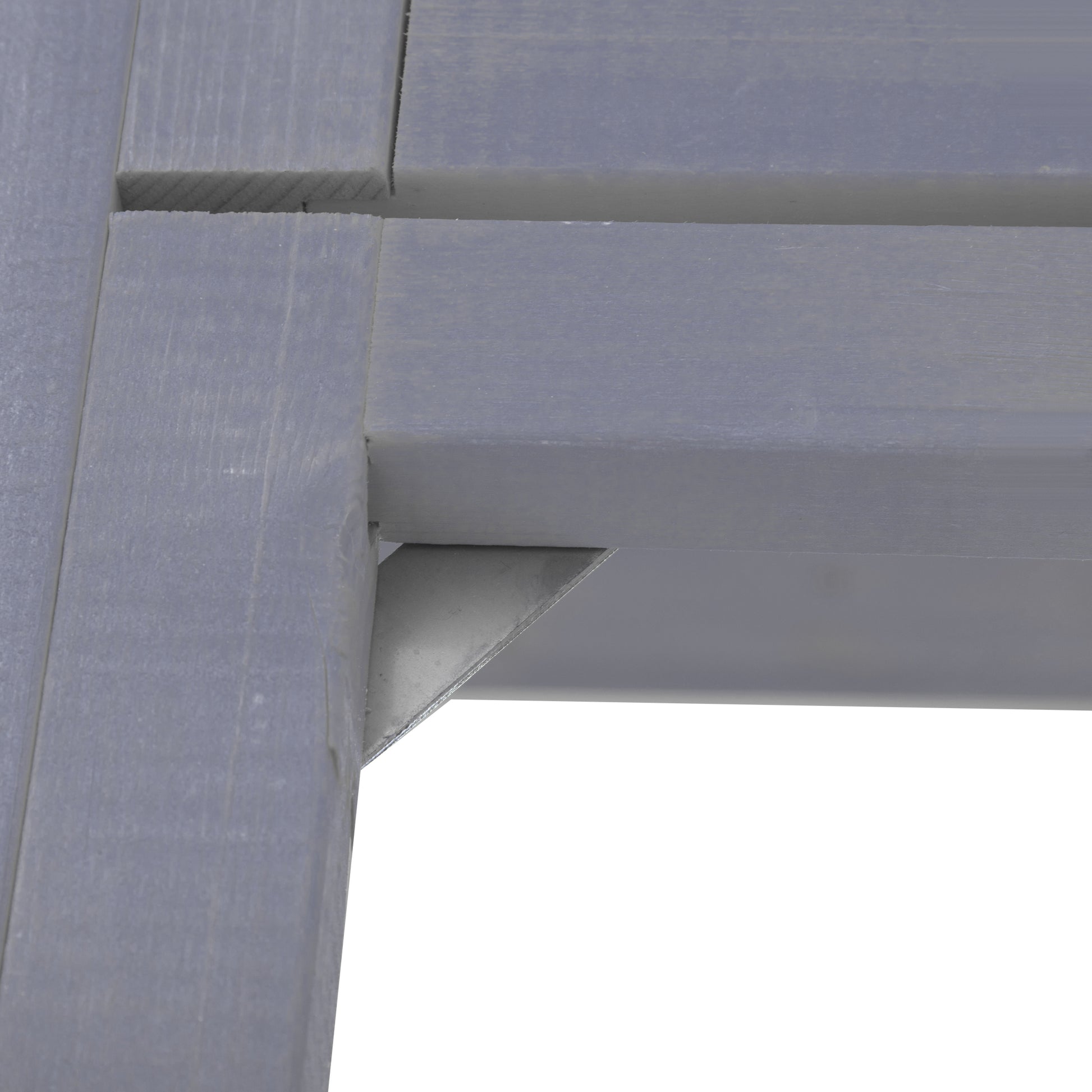 Closeup of grey wooden slats with a metal bracket showing construction detail of outdoor furniture