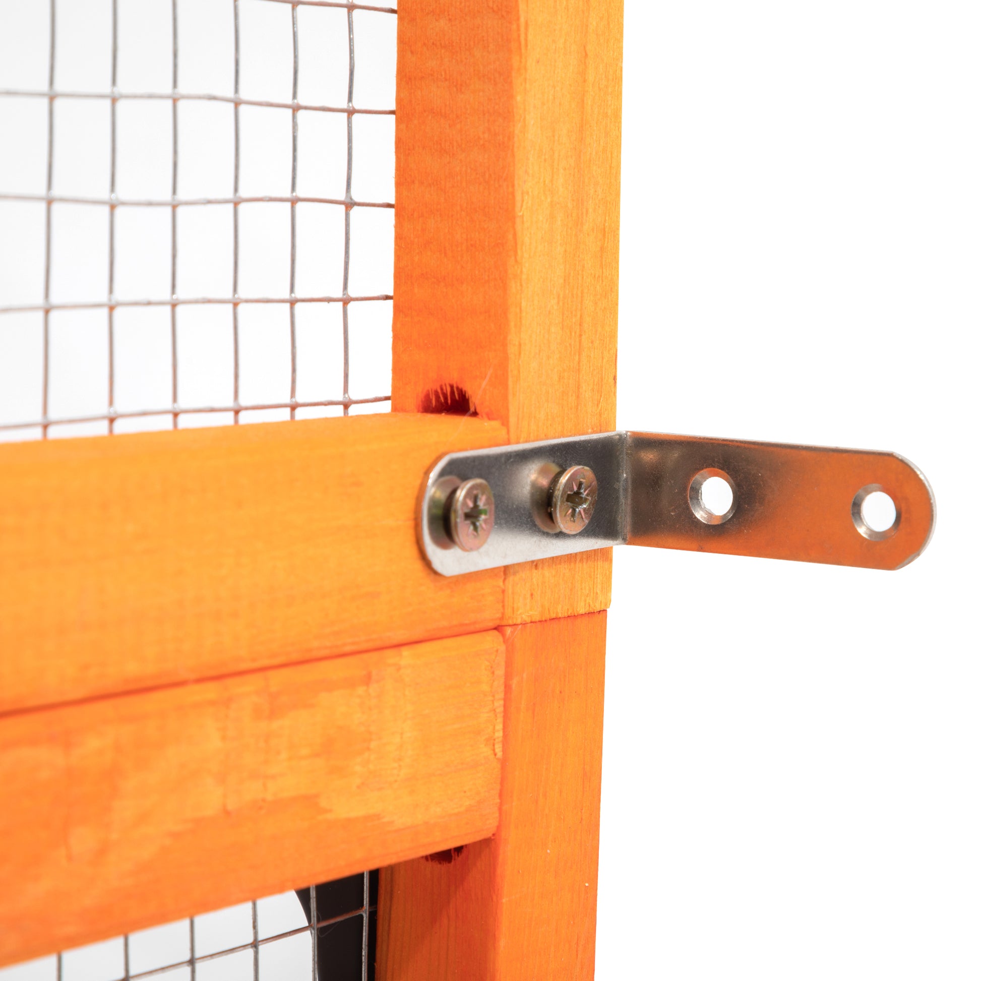 Closeup of orange wooden pet hutch frame with metal Lbracket and screws