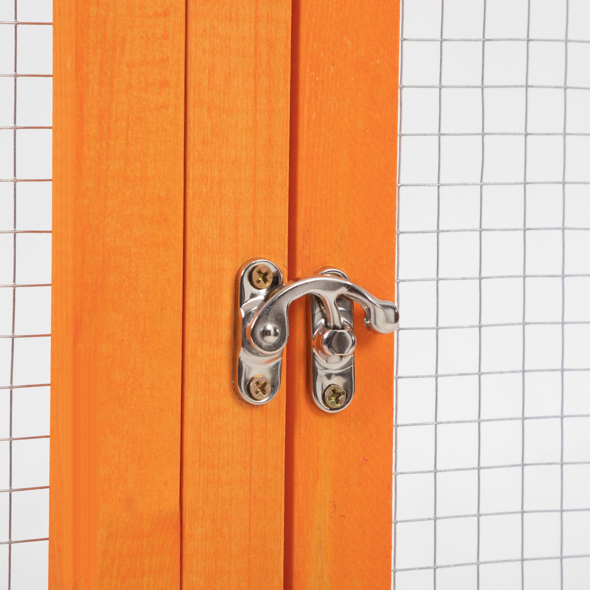 Orange wooden pet cage door with silver latch detail