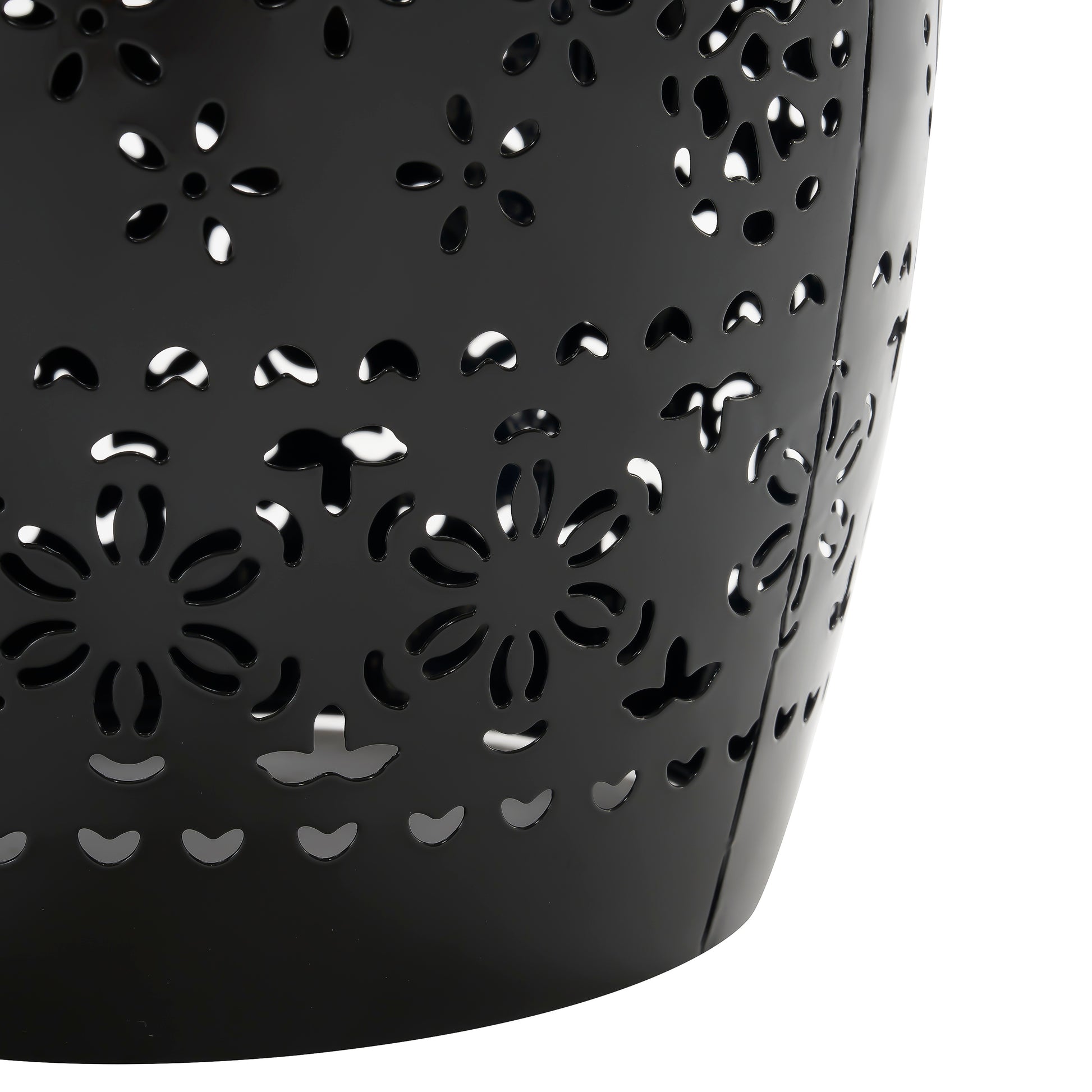 Black metal lantern with intricate floral cutouts and a glossy finish