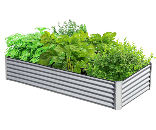 Rectangular corrugated metal raised garden bed filled with lush green herbs and plants