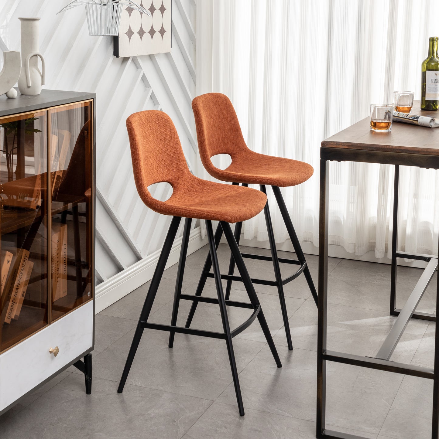 Orange textured fabric bar stool with black metal legs and cutout detail