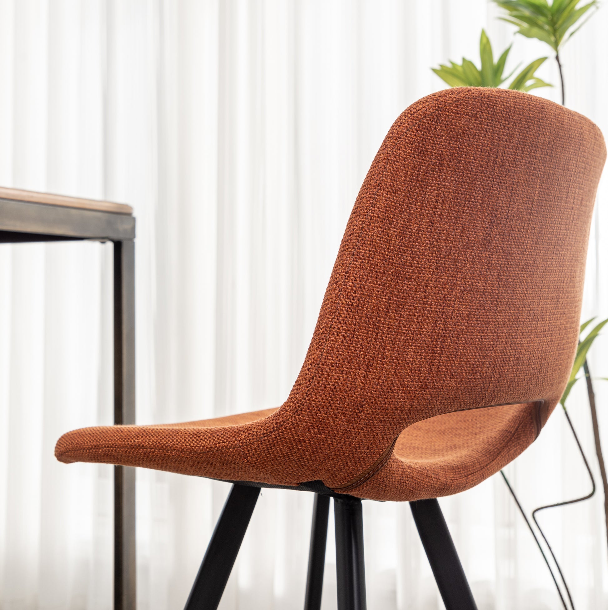 Orange textured fabric accent chair with black metal legs modern design