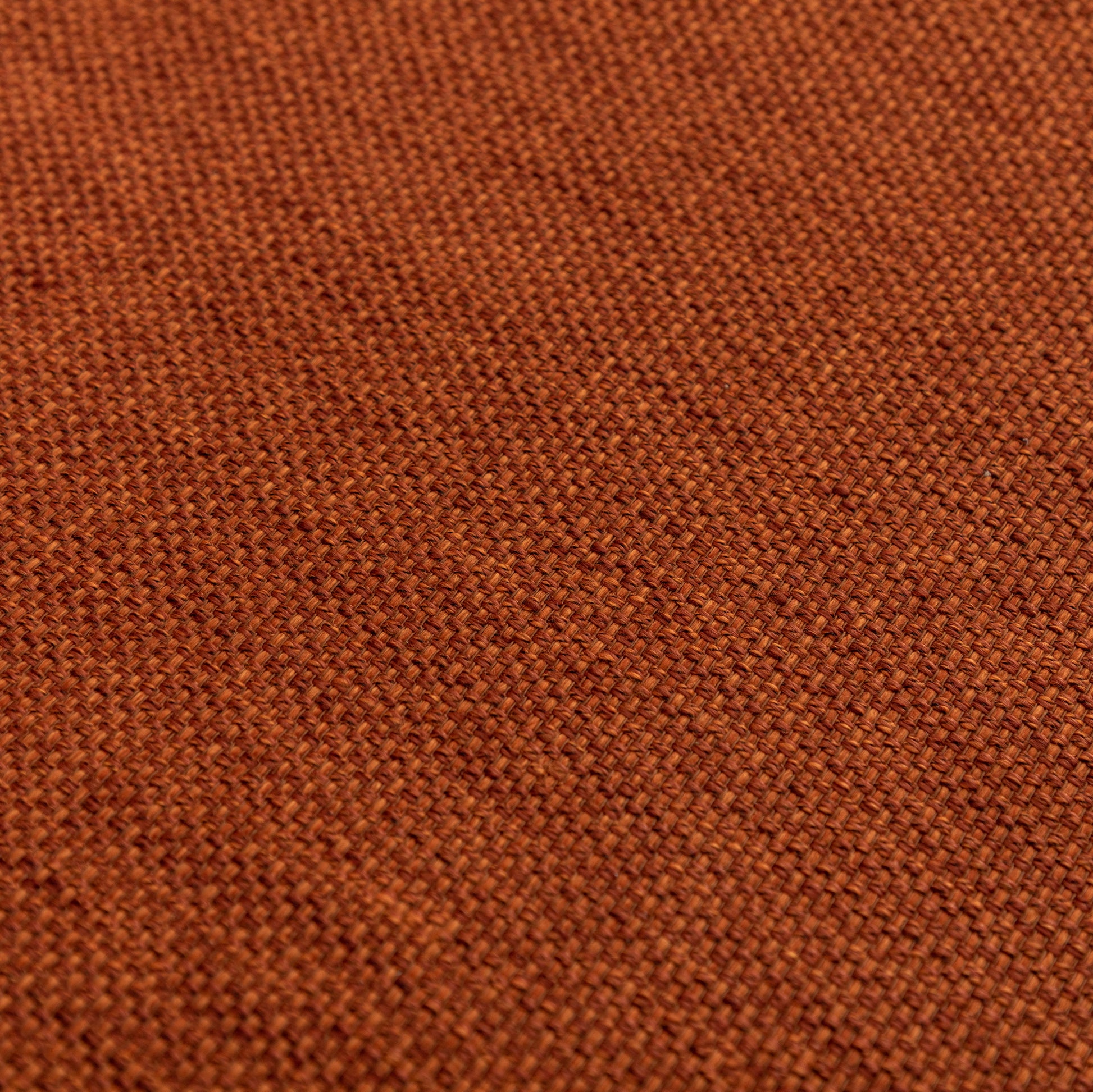 Closeup of textured burnt orange linen fabric weave ideal for upholstery