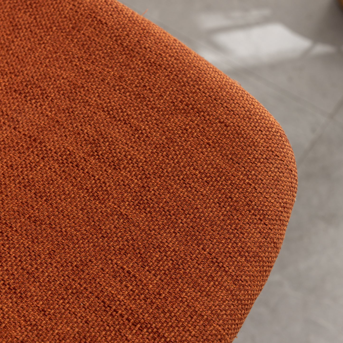 Closeup of textured burnt orange linen fabric perfect for upholstery projects