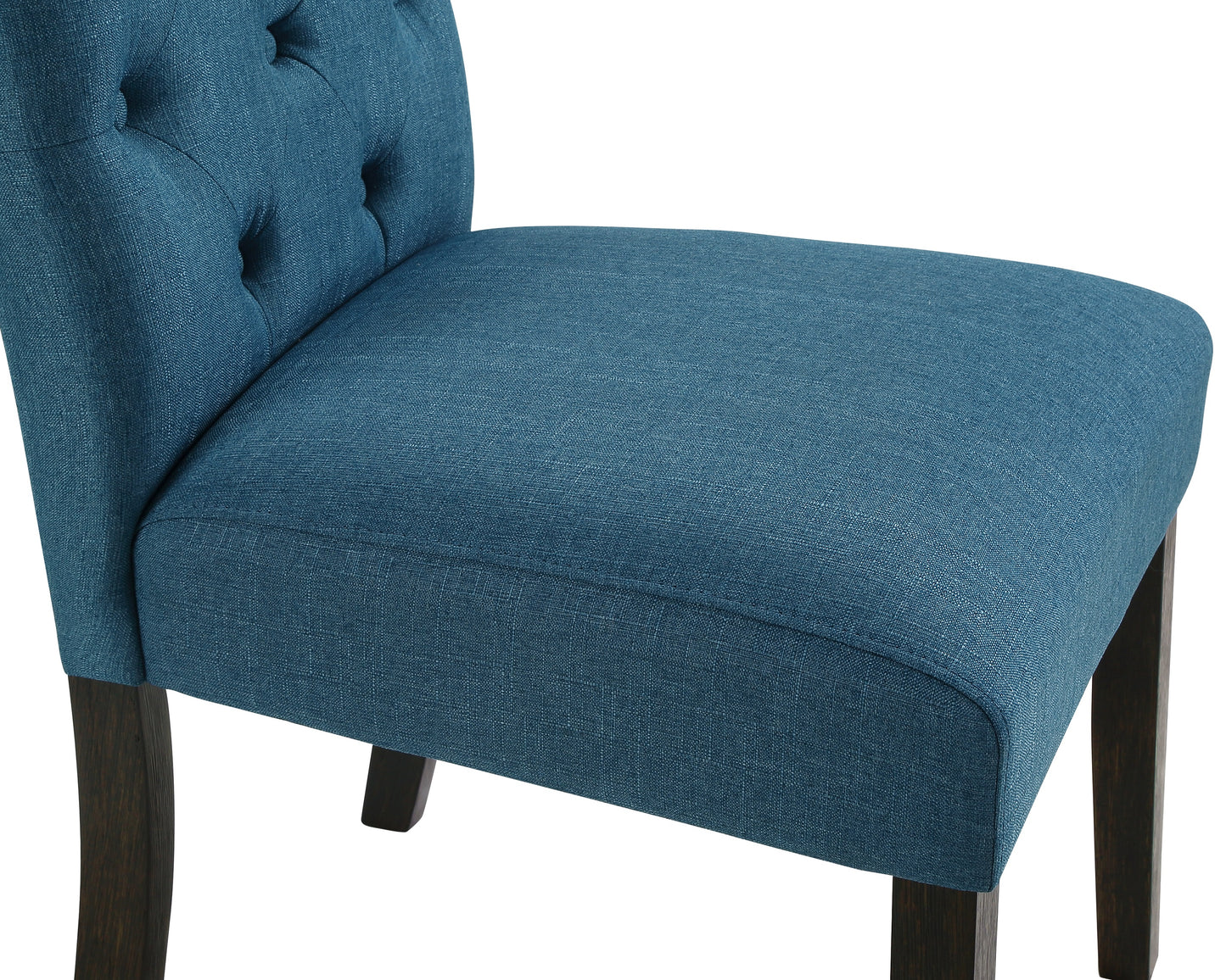 Closeup of a tufted blue fabric chair back with dark wood legs