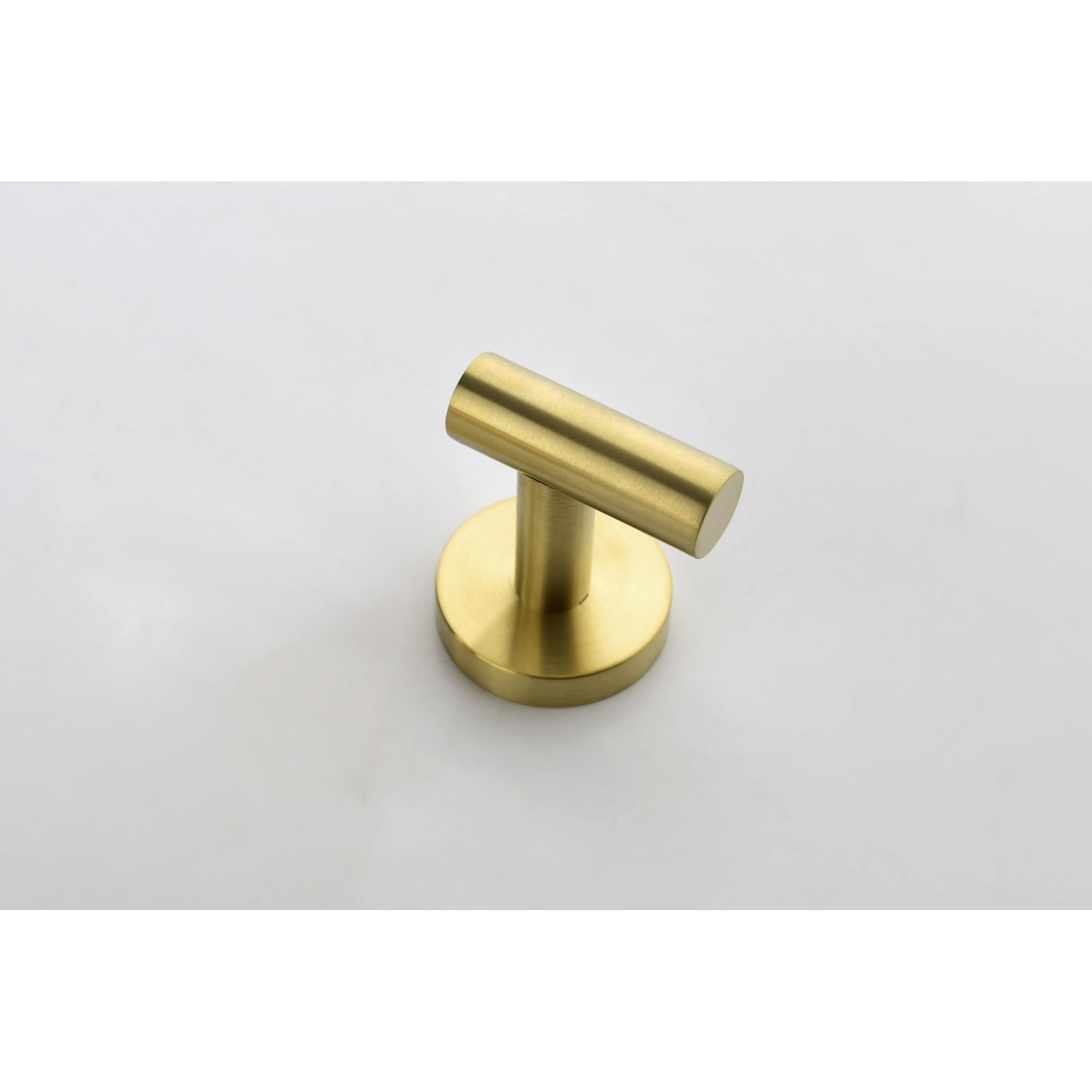 Brushed brass wall hook with a modern cylindrical design perfect for bathrooms